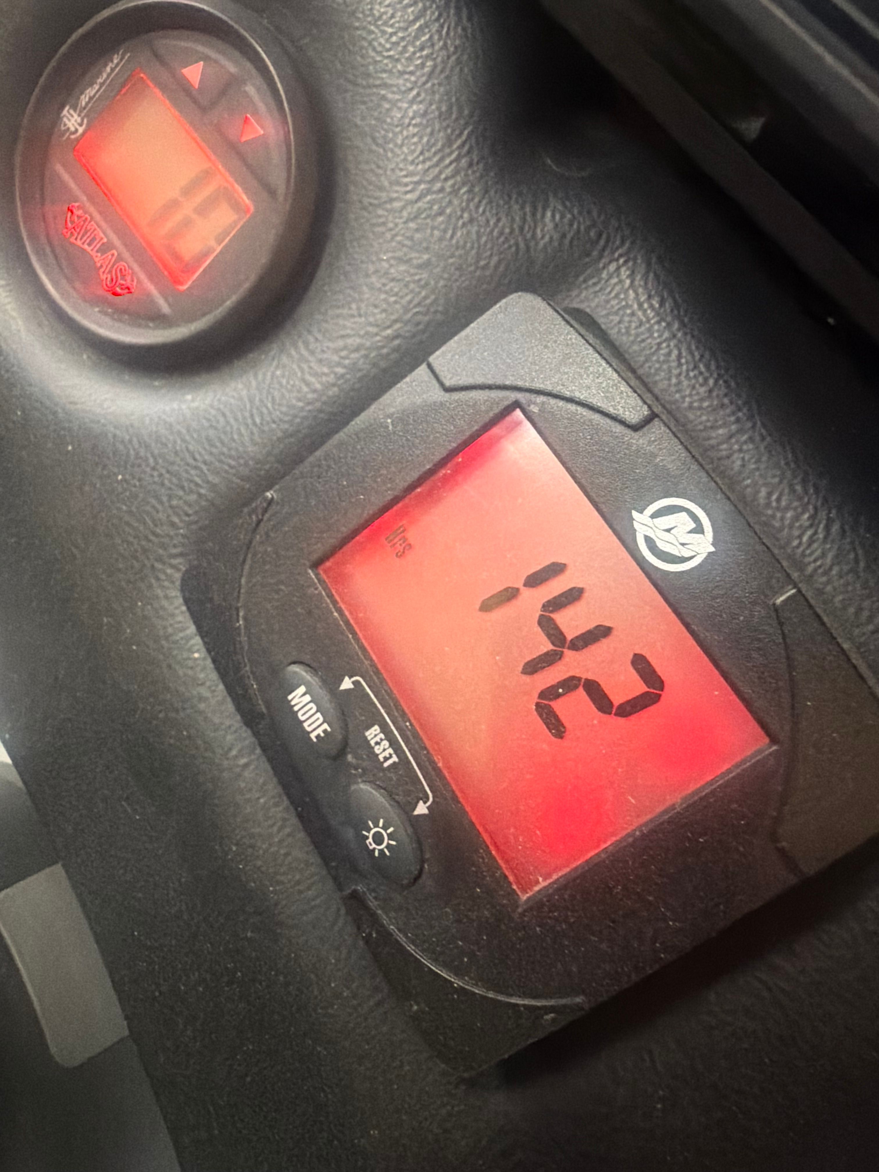 Close-up of two digital displays with red screens and black casings.