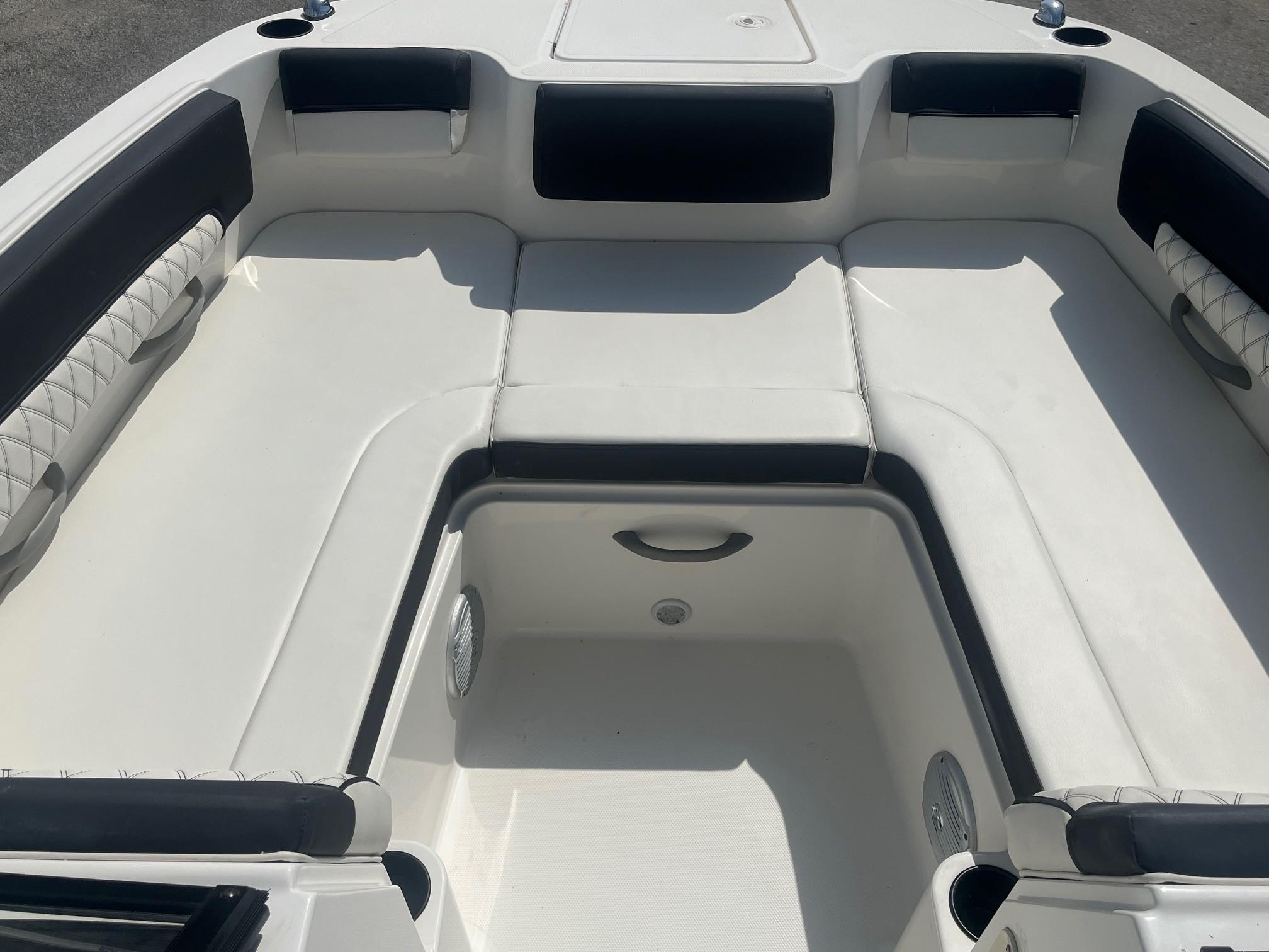 Interior seating of 2022 Bayliner DX 2200 boat, featuring white and black upholstery.