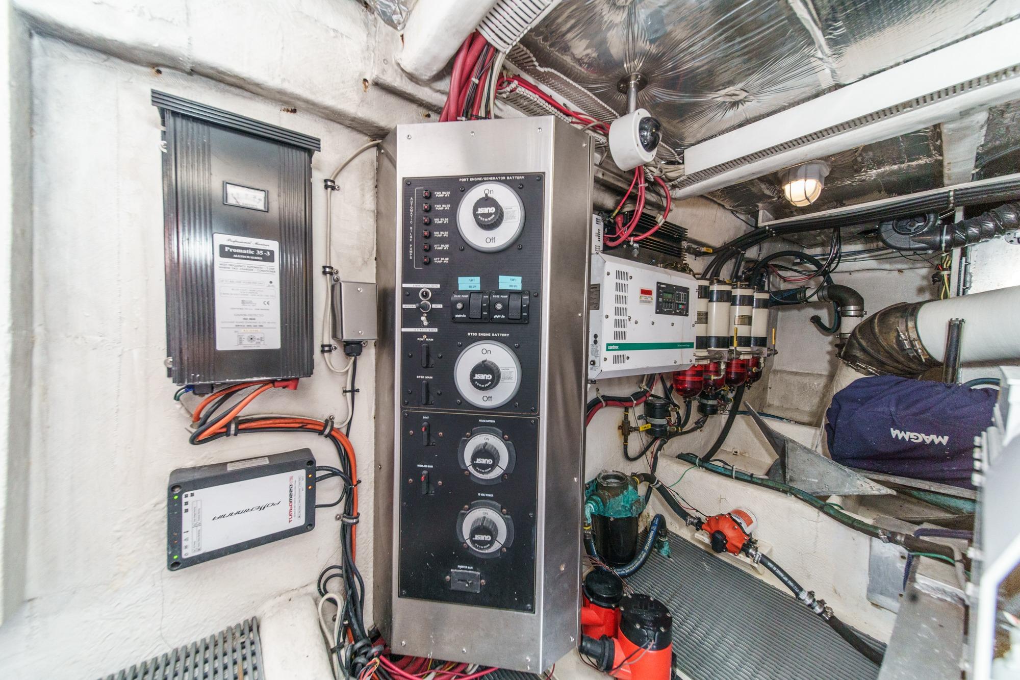 Engine room of 2000 Bayliner 5788 Pilot House Motoryacht with control panels and wiring.