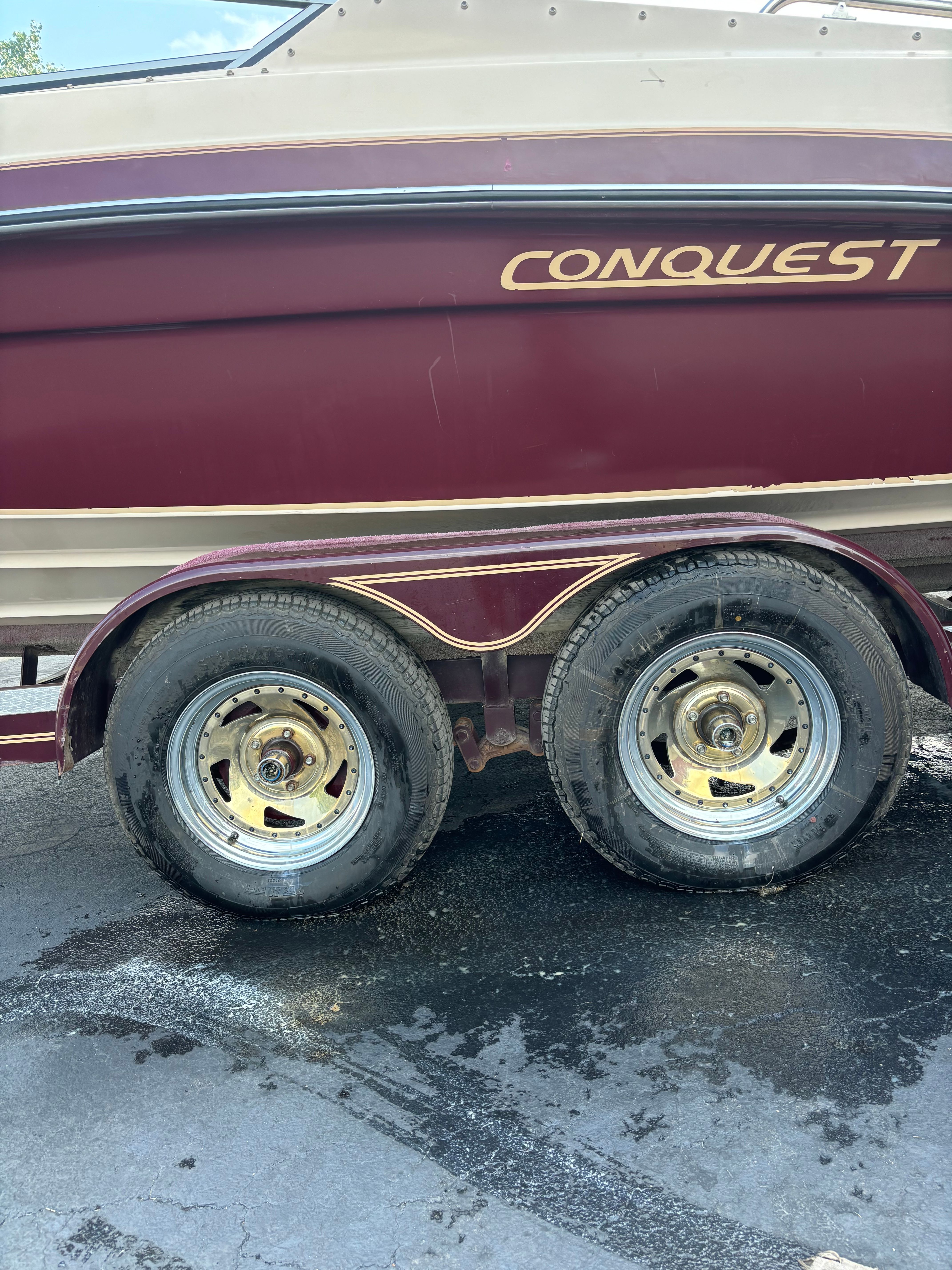 1996 Conquest 2100 boat on trailer with dual wheels.