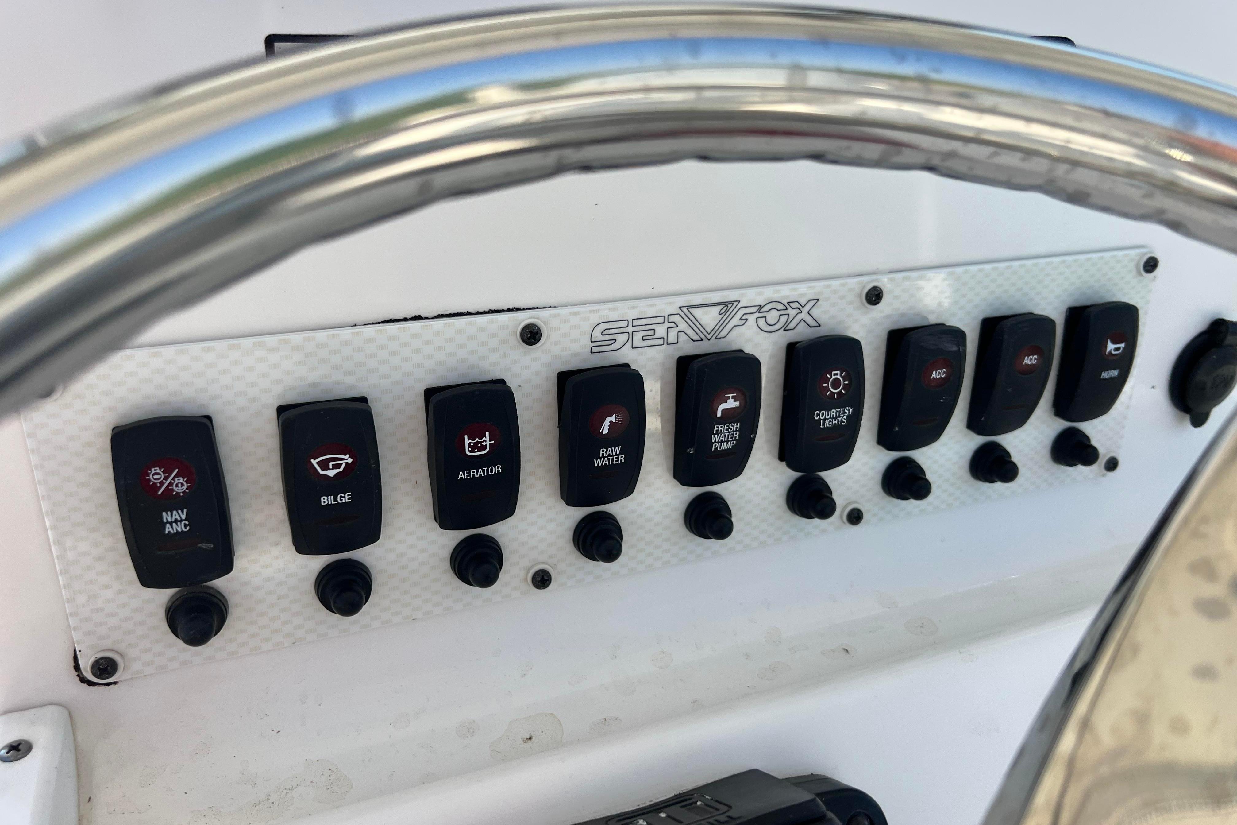 Control panel of a 2012 Sea Fox 206 Center Console boat with labeled switches.