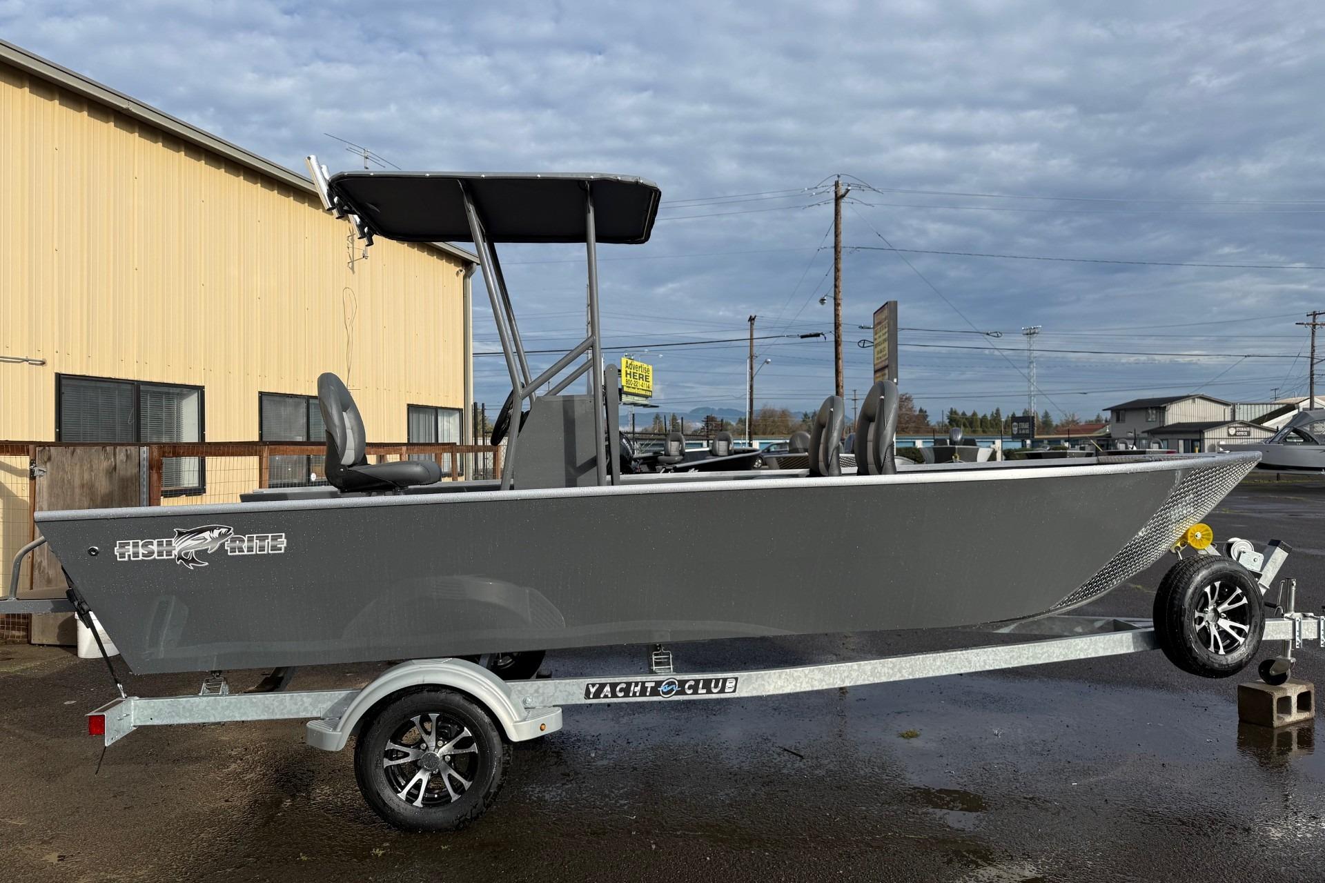 2026 Fish Rite Angler 18 boat on trailer, parked outdoors under cloudy sky.