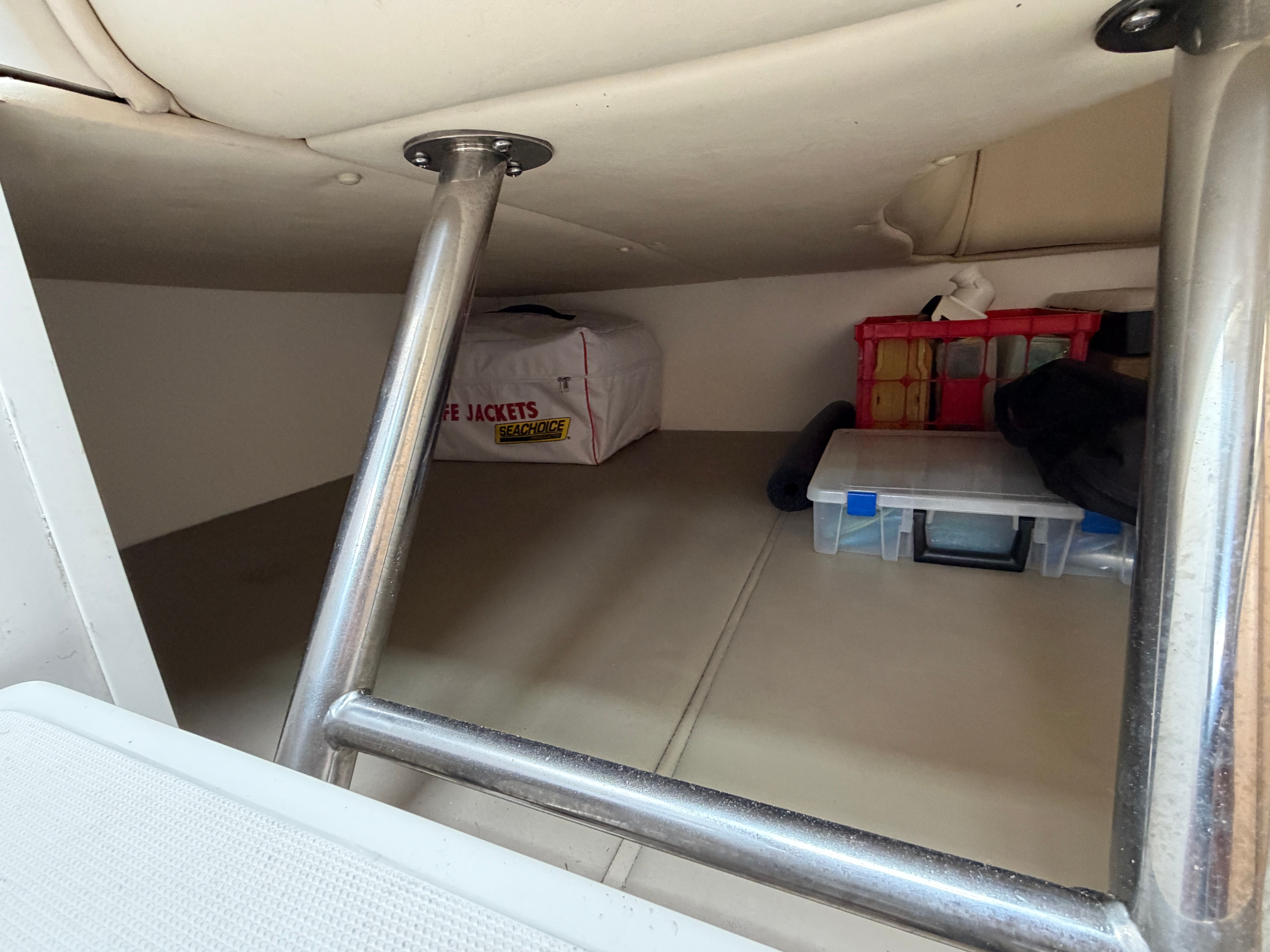 Under-deck storage with life jackets and equipment.