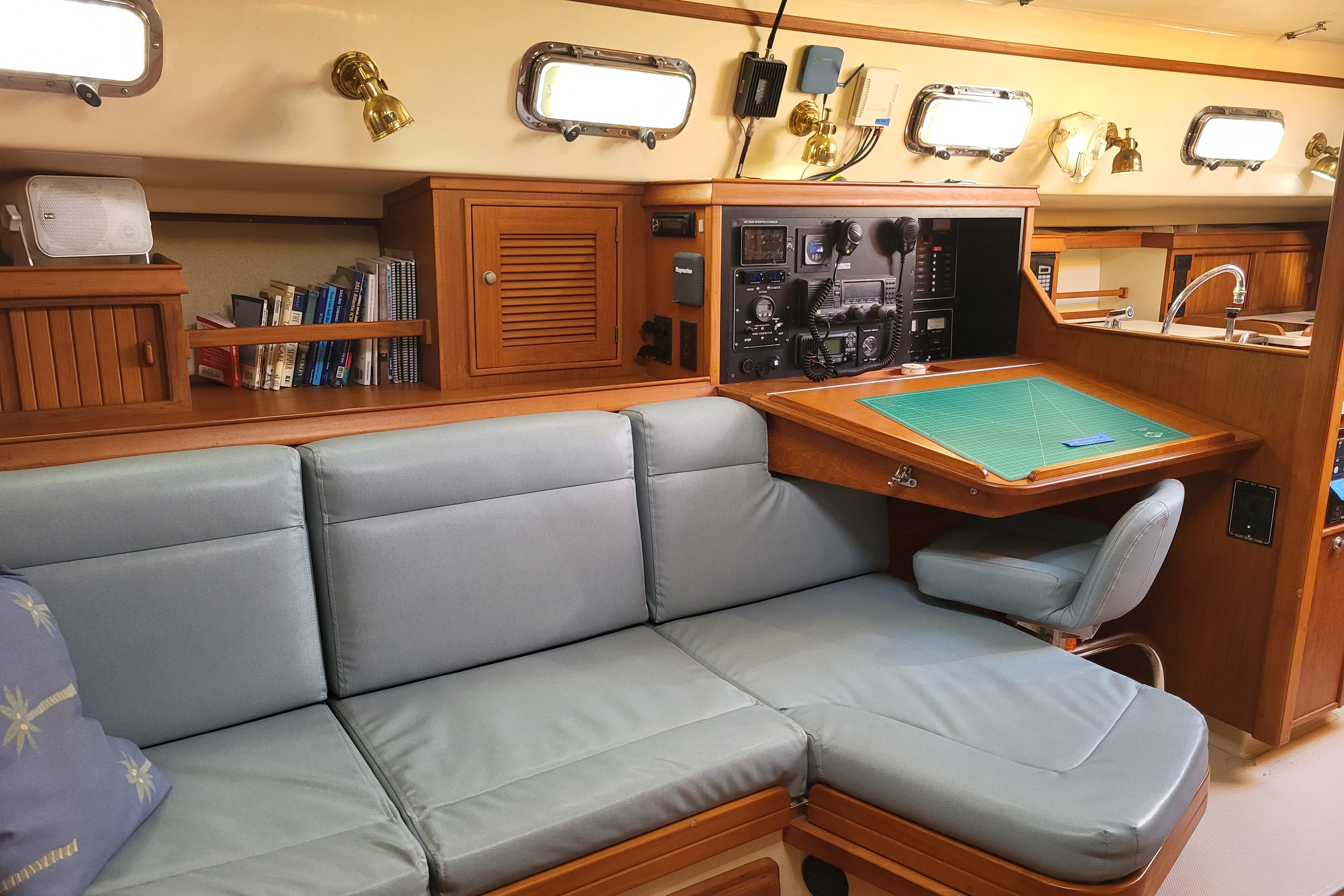 Interior of 2000 Island Packet 420 yacht with navigation station and cozy seating area.