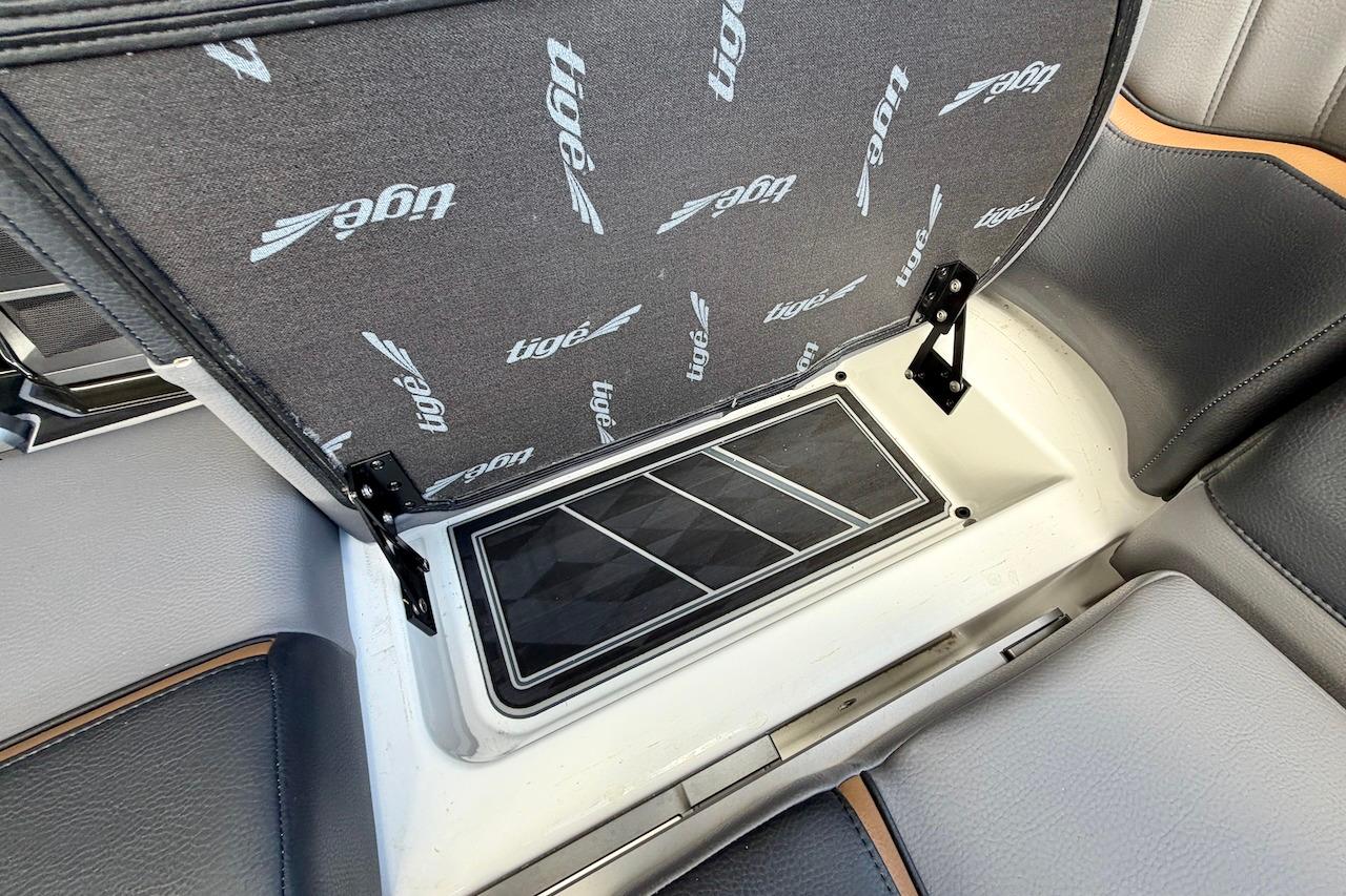 2025 Tigé Ultré 25ZX boat interior storage compartment with branded upholstery.