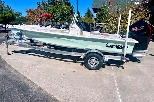 2026 Mako 18 Pro Skiff boat on trailer, parked outdoors.
