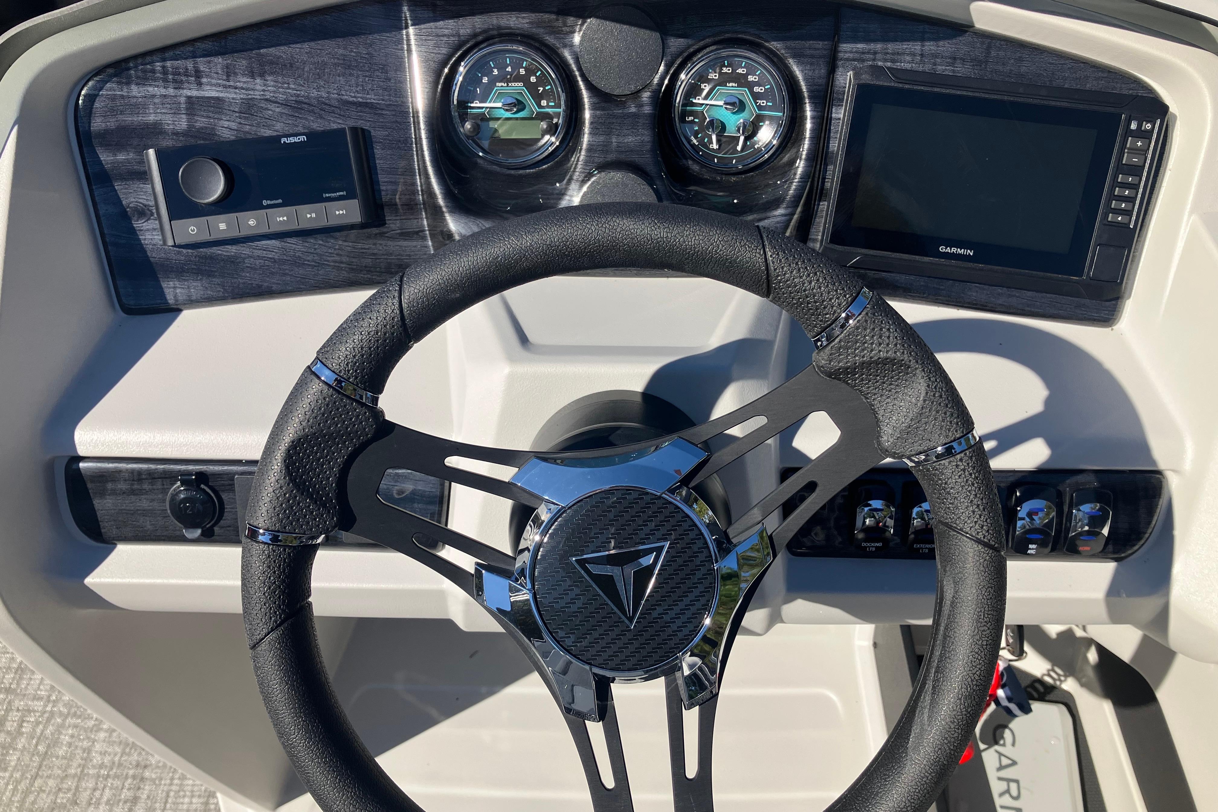 2026 Tahoe Pontoon LTZ Quad Lounger dashboard with steering wheel and control panel.