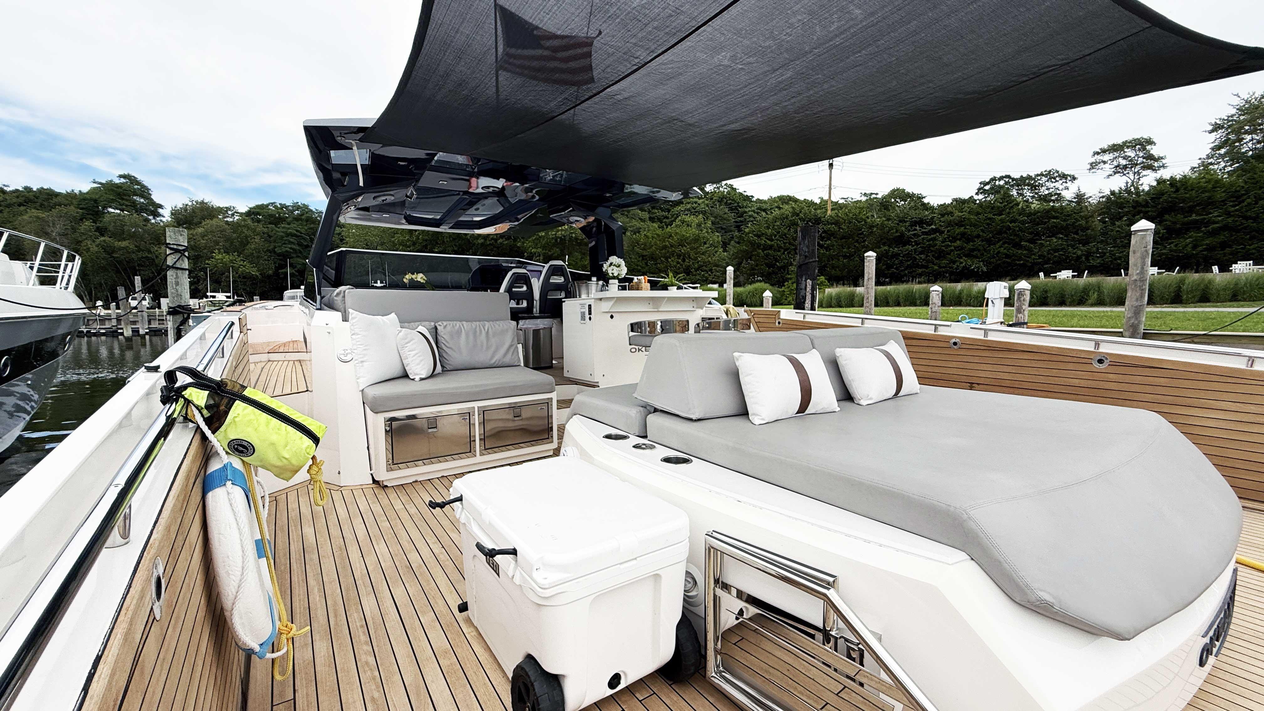 Luxurious 2023 OKEAN 57 yacht deck with seating, canopy, and modern amenities.