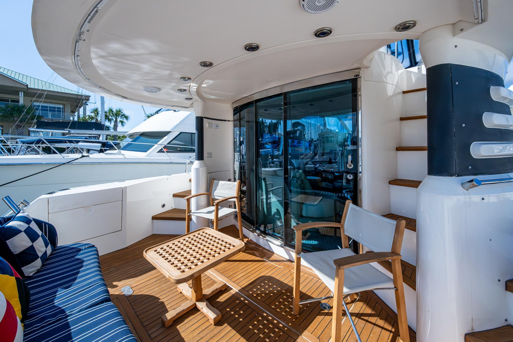 Luxurious 2000 Fairline Squadron 52 yacht deck with seating and table.