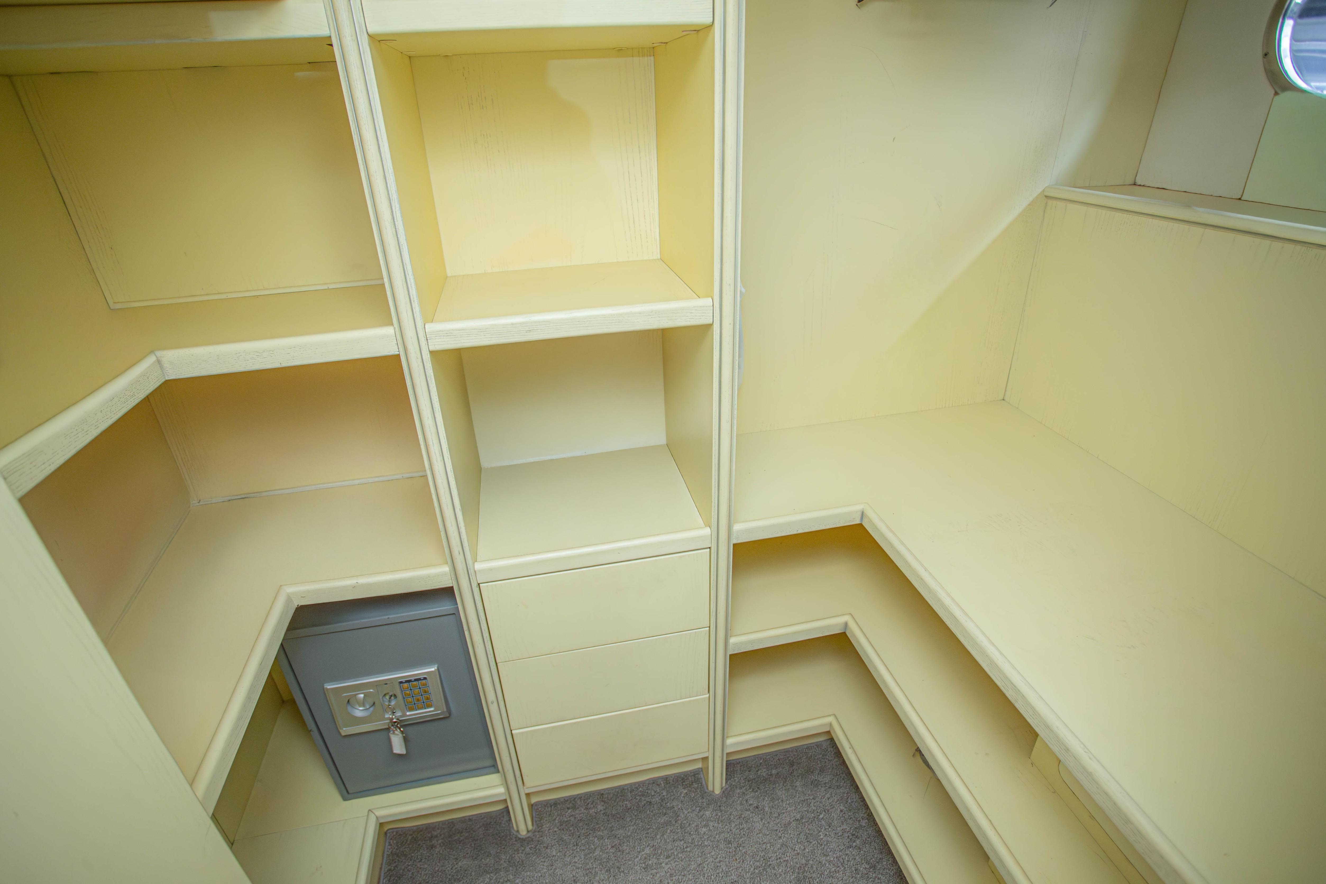 Interior storage space with shelves and safe on 2014 Fifth Ocean Yachts Explorer.