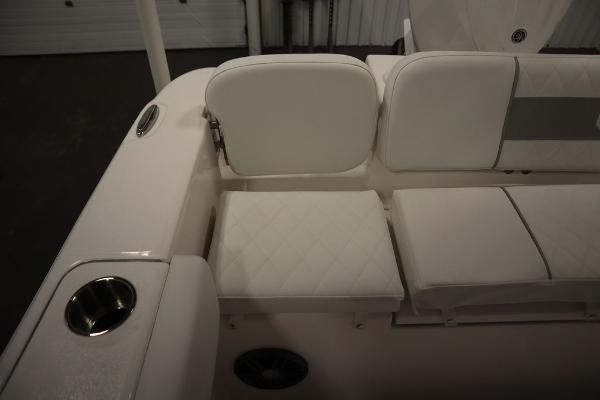2025 Sea Fox 228 Commander boat interior with white cushioned seating and cup holder.