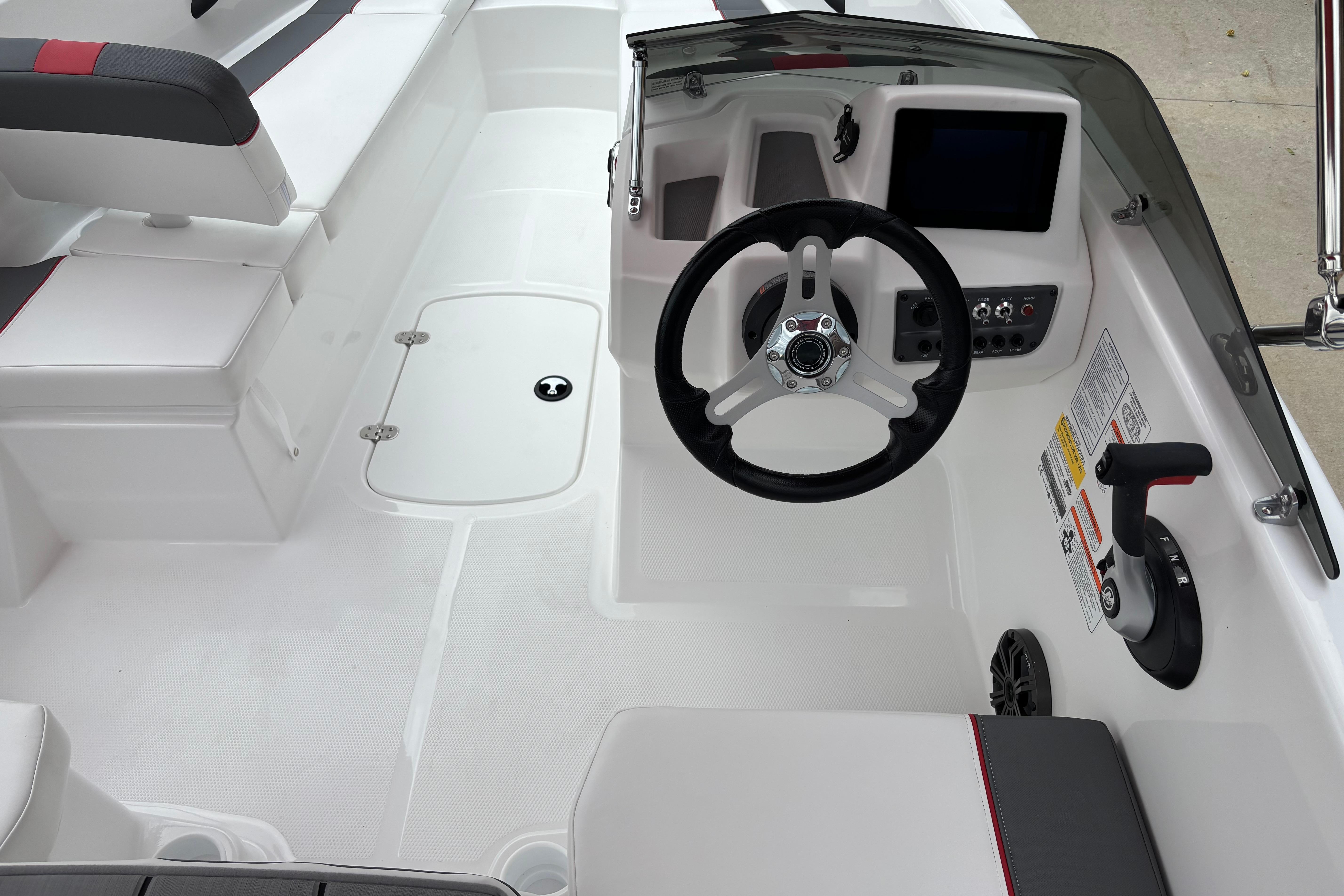 2026 Tahoe T16 boat interior with steering wheel, control panel, and seating.