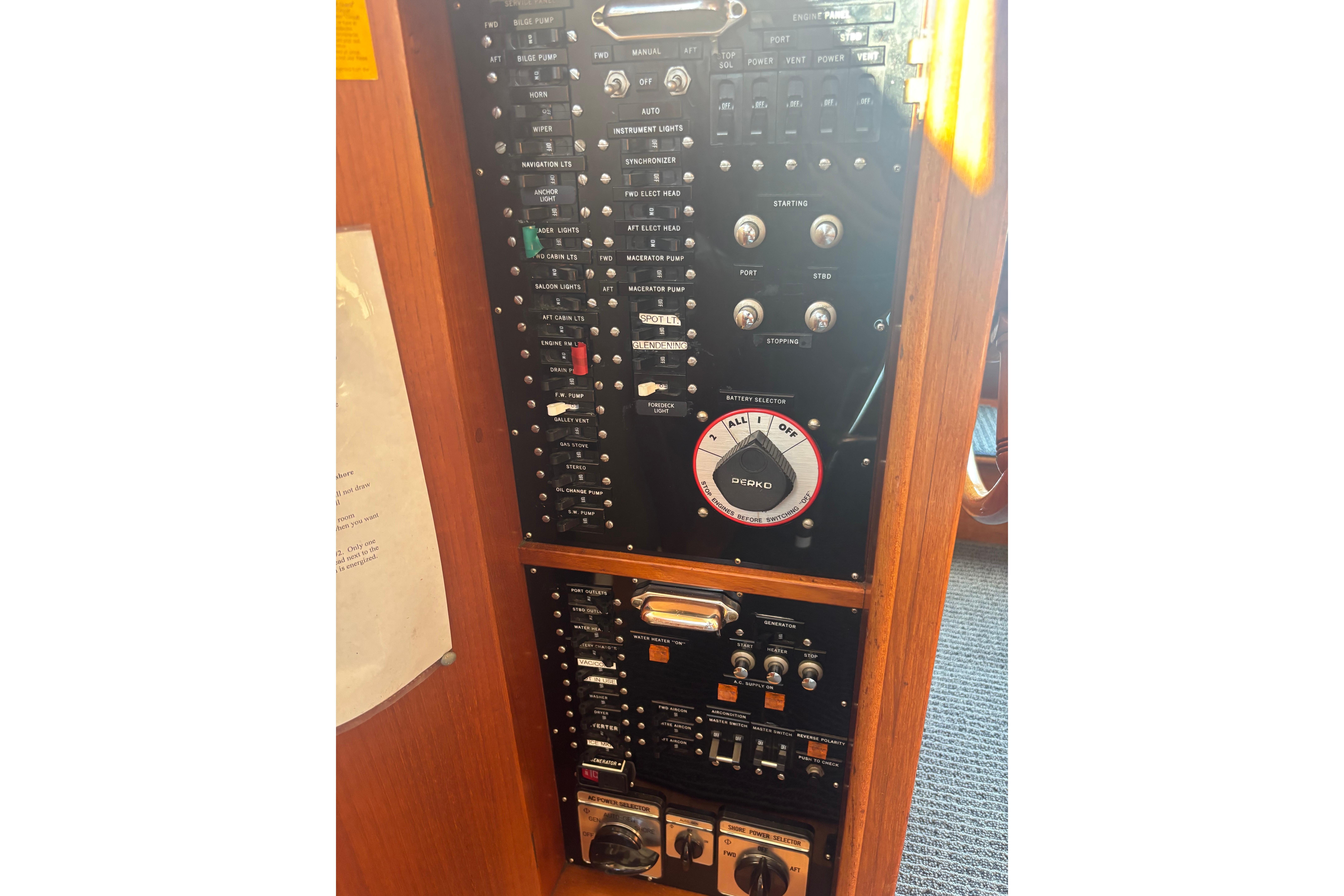 Control panel of 1989 Grand Banks 46 Classic yacht with various switches and dials.