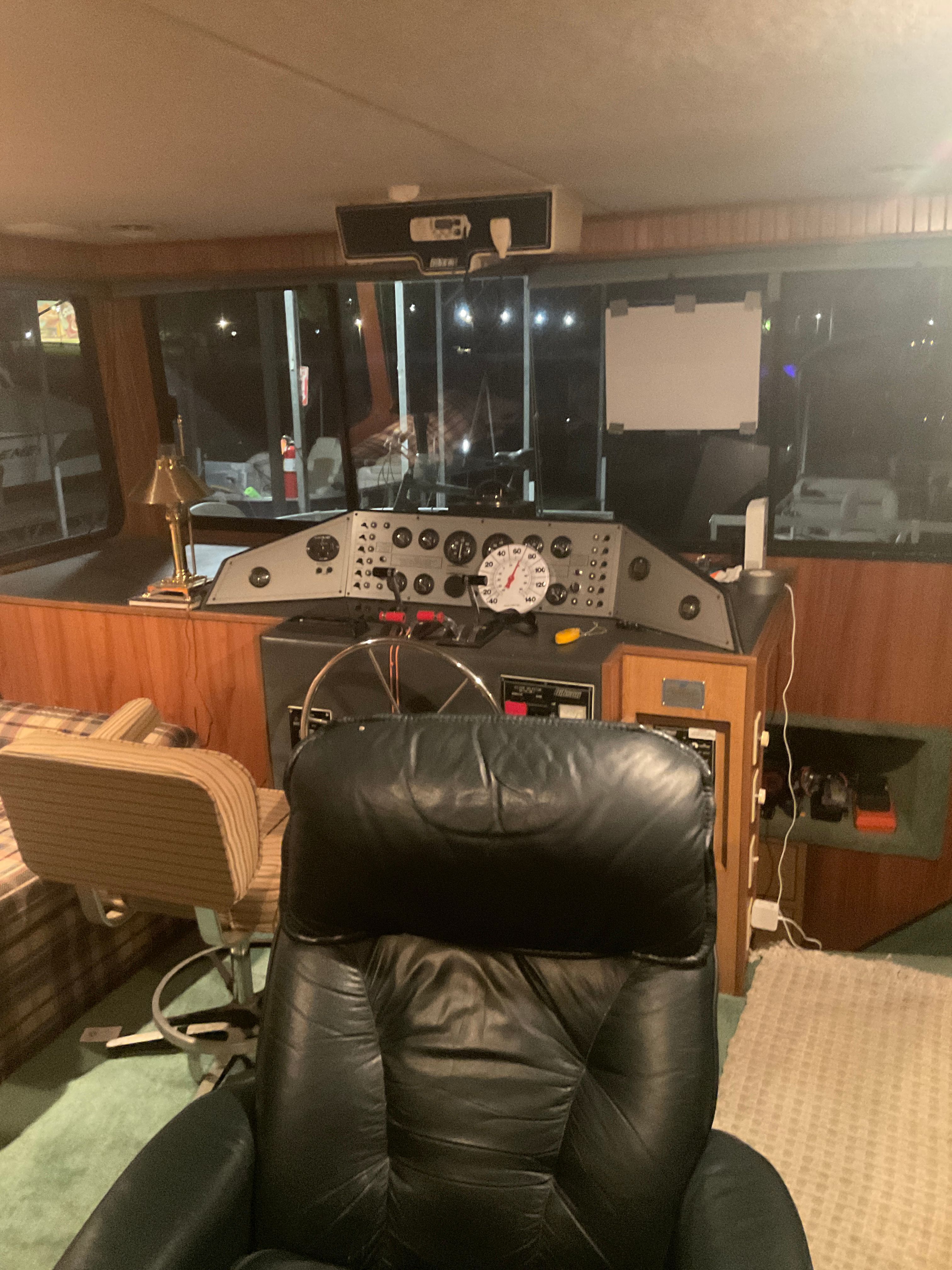 The image shows the helm of a 1996 Gibson 44 Standard with a leather seat and instrument panel.