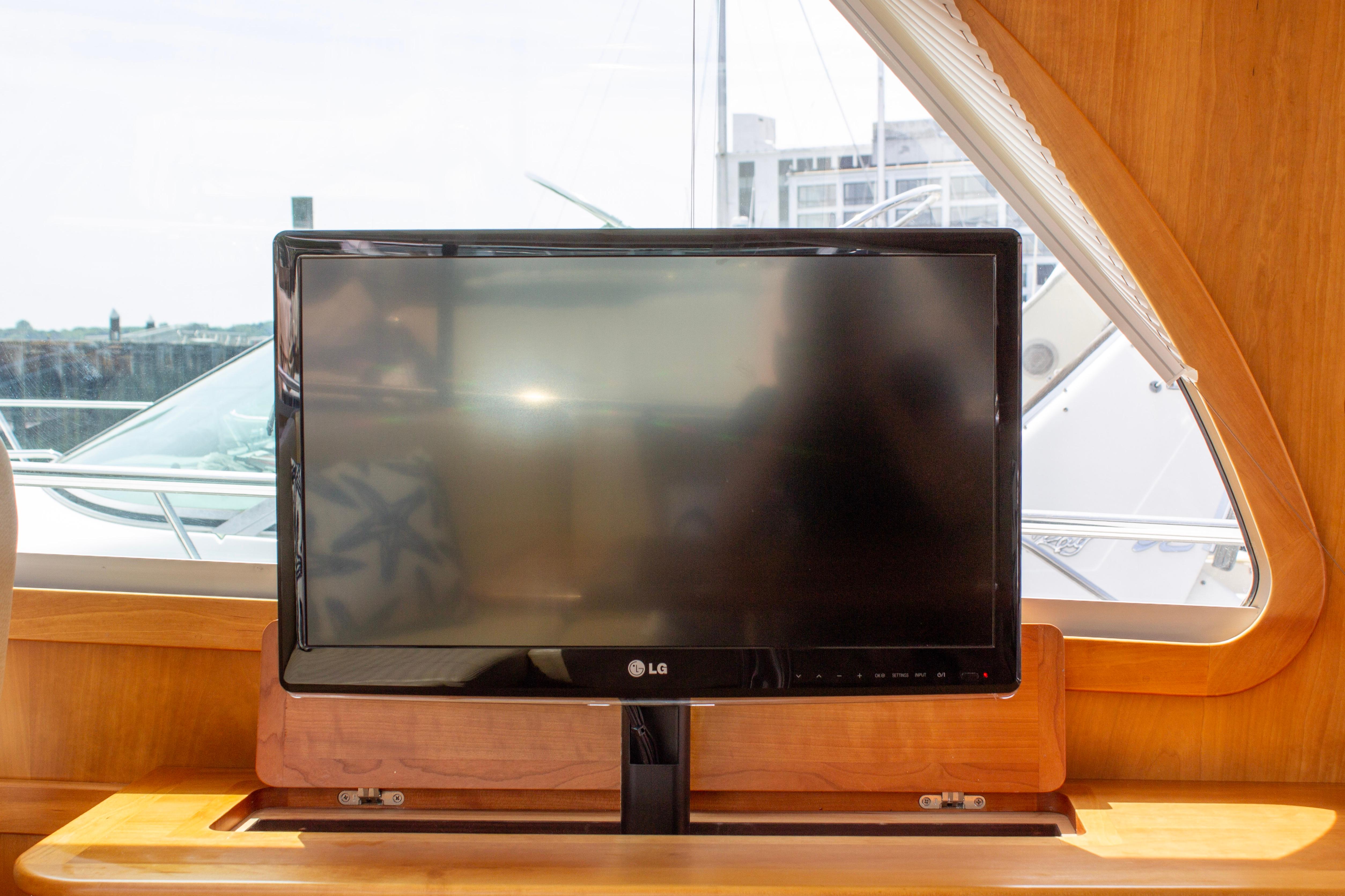 LG TV inside 2013 Sabre 38 Salon Express yacht, wooden interior, window view.