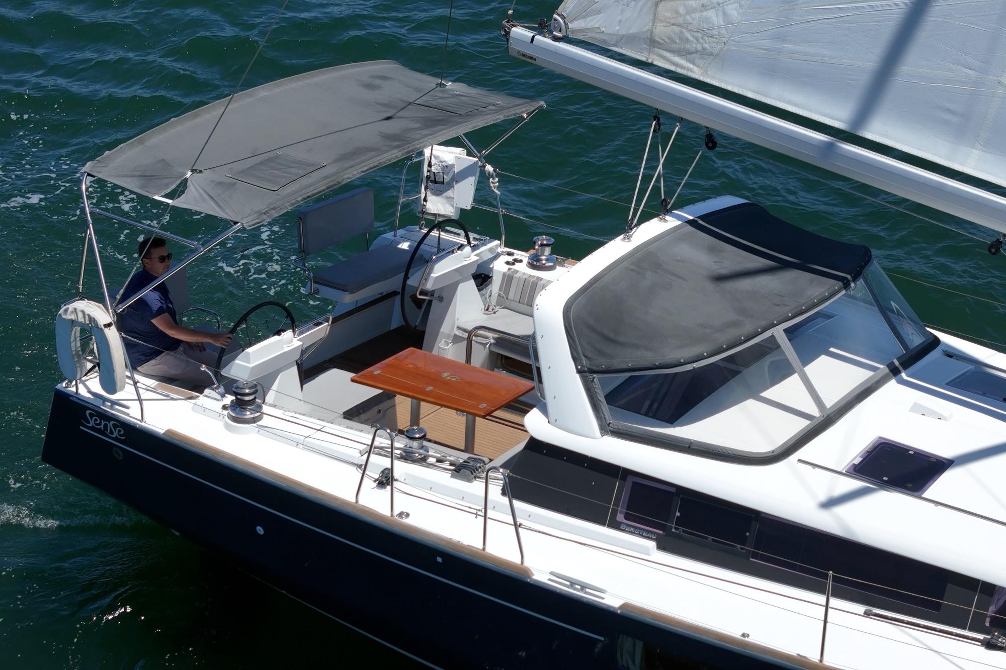 2017 Beneteau Sense 50 sailboat cruising on open water, featuring a spacious cockpit and canopy.