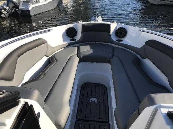 2020 Rinker 29QX BR boat interior with cushioned seating and speakers.
