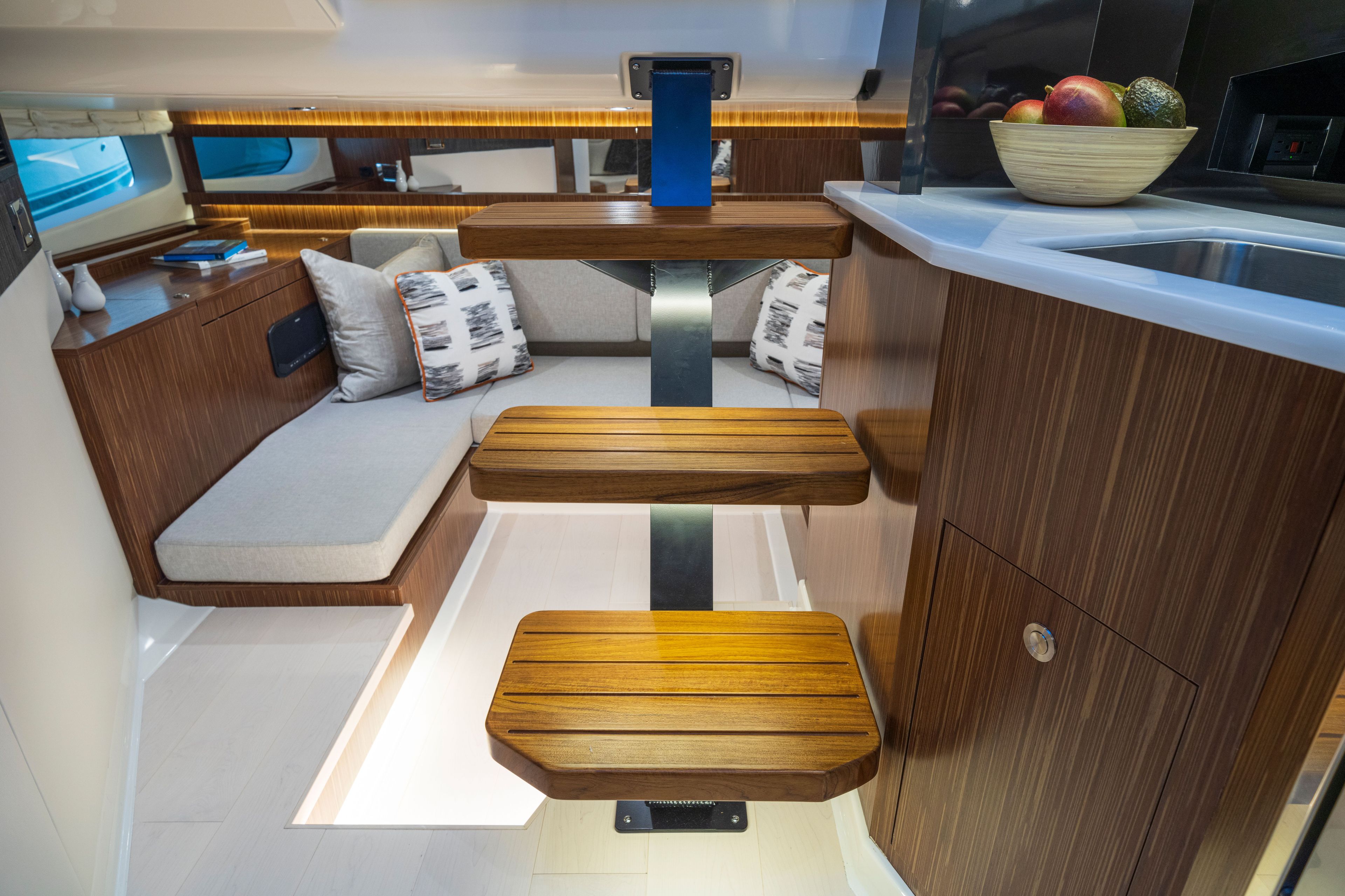 Interior of the Sea Ray Sundancer 370 Outboard with wooden steps and cozy seating area.