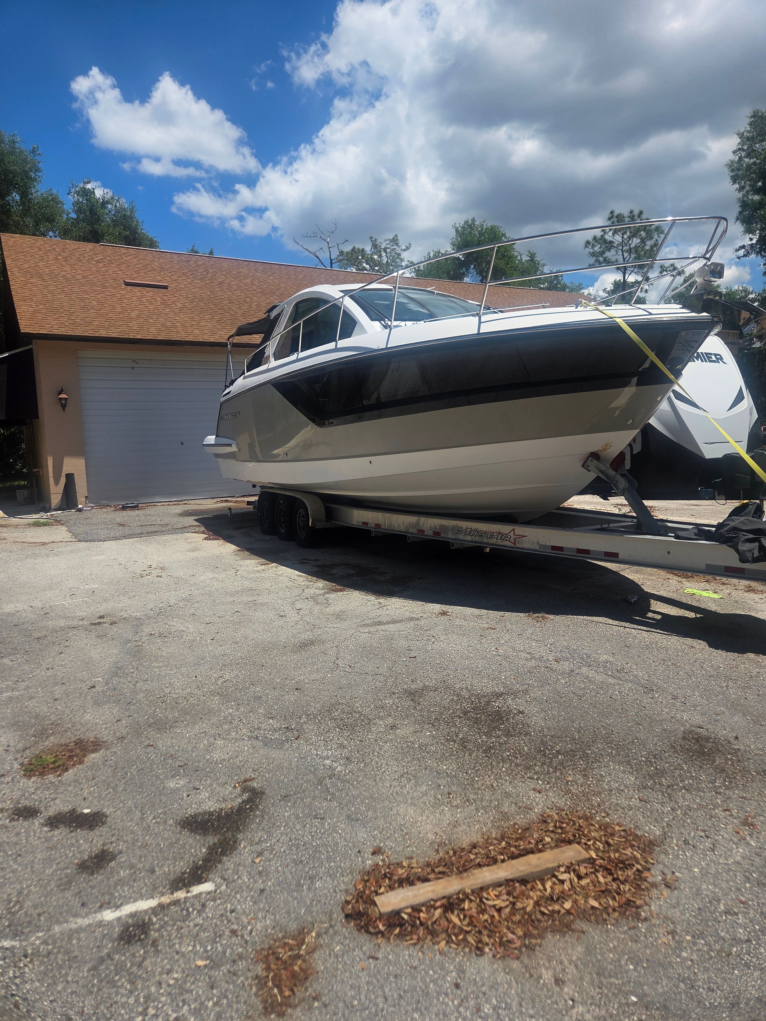 2019 Monterey 360SC boat on trailer in front of garage.