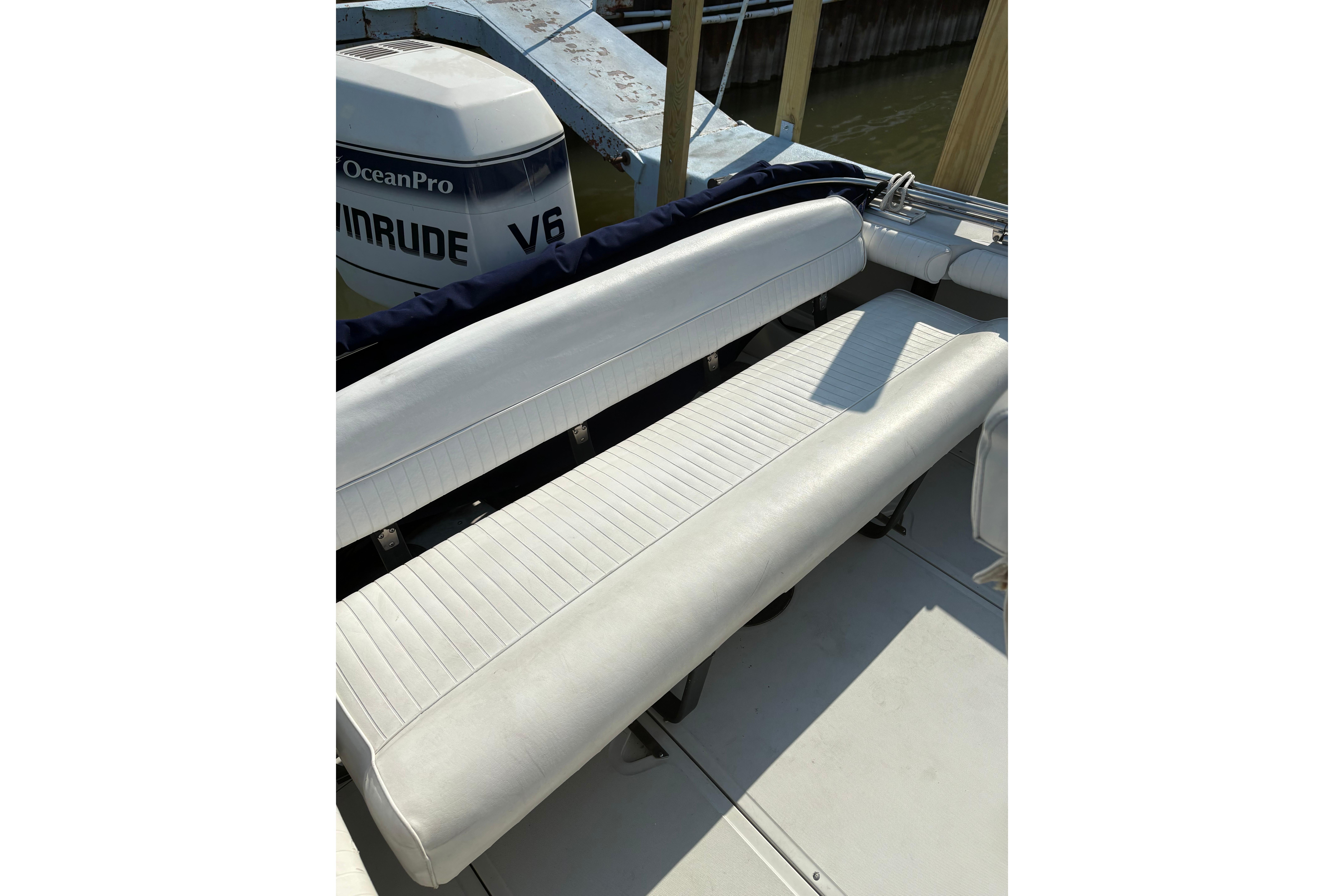 1993 Boston Whaler 21 Outrage boat with white seating and Evinrude V6 engine.