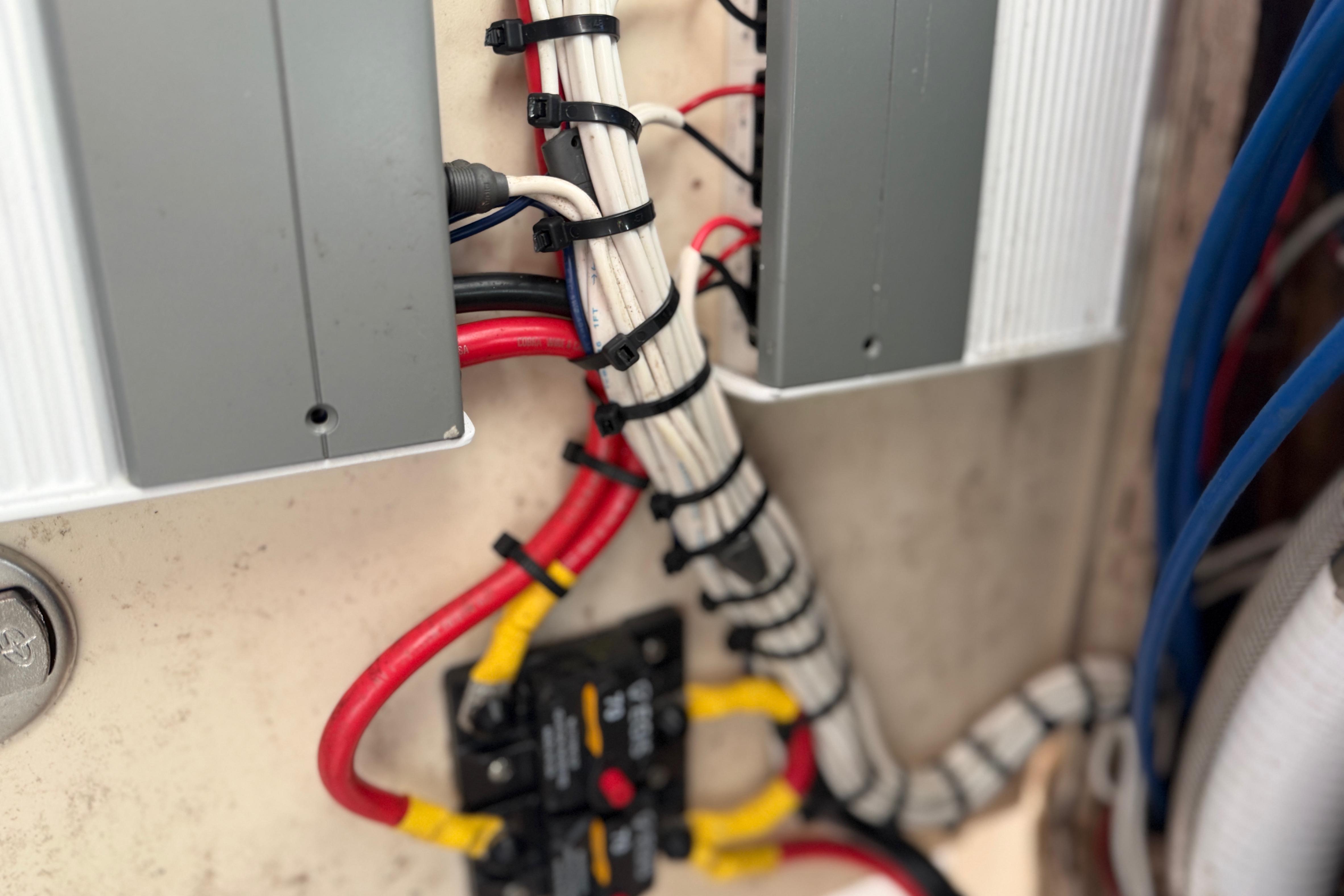 Electrical wiring setup on a 2004 Grady White 273 boat, featuring organized cables and connectors.