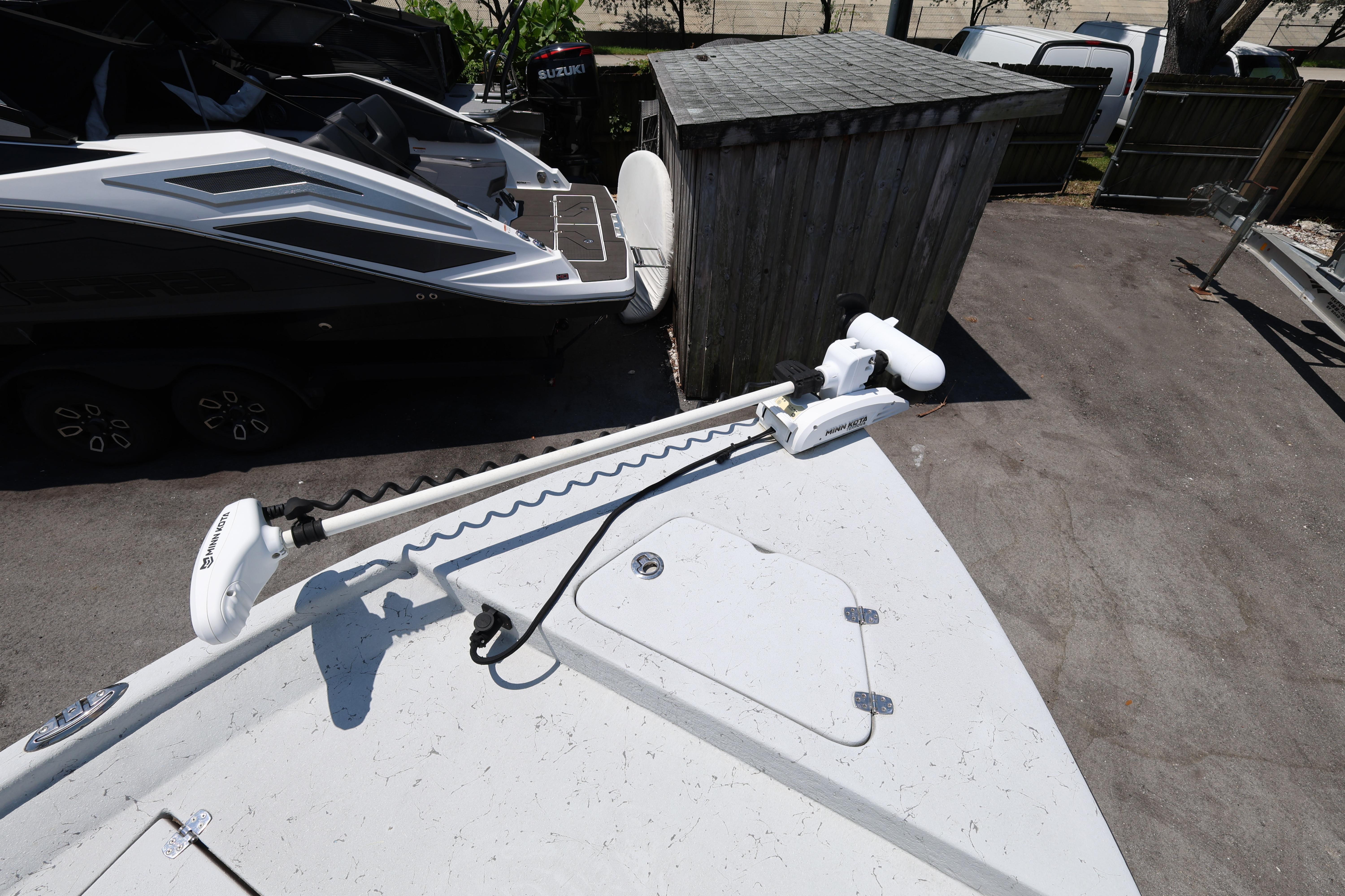 2021 Blazer Bay 2400 boat with Minn Kota trolling motor in a parking area.