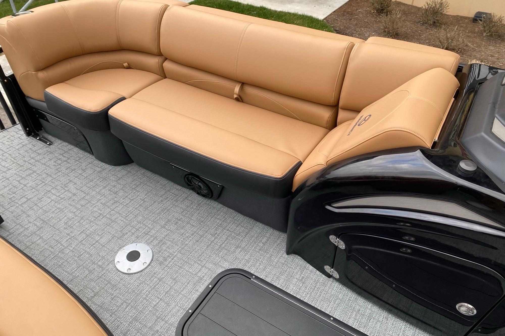 Luxurious seating on 2026 Regency 230 DL boat with tan upholstery and sleek design.