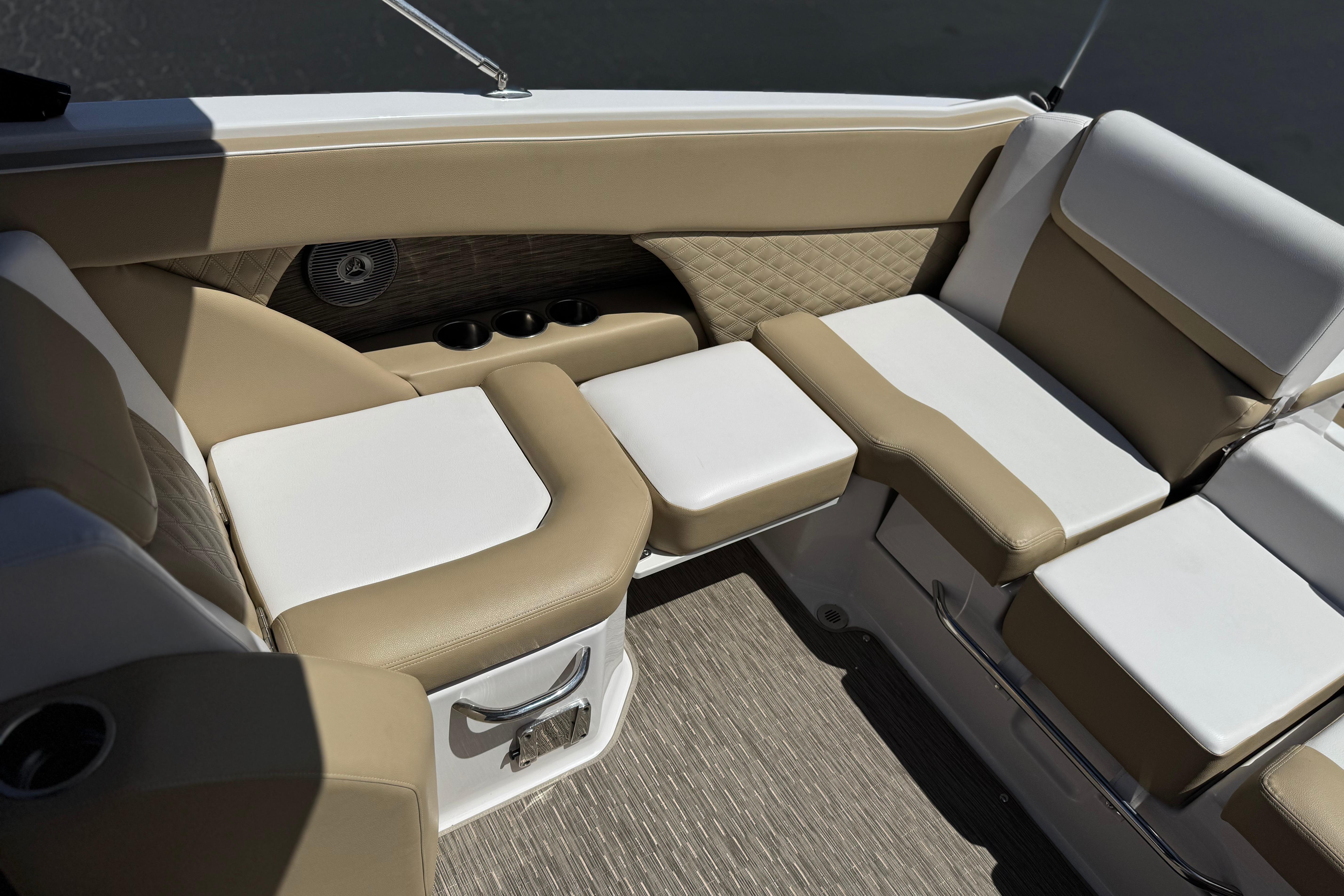 Luxurious seating area on a 2017 Scarab 255 H.O. Platinum boat, featuring beige and white upholstery.