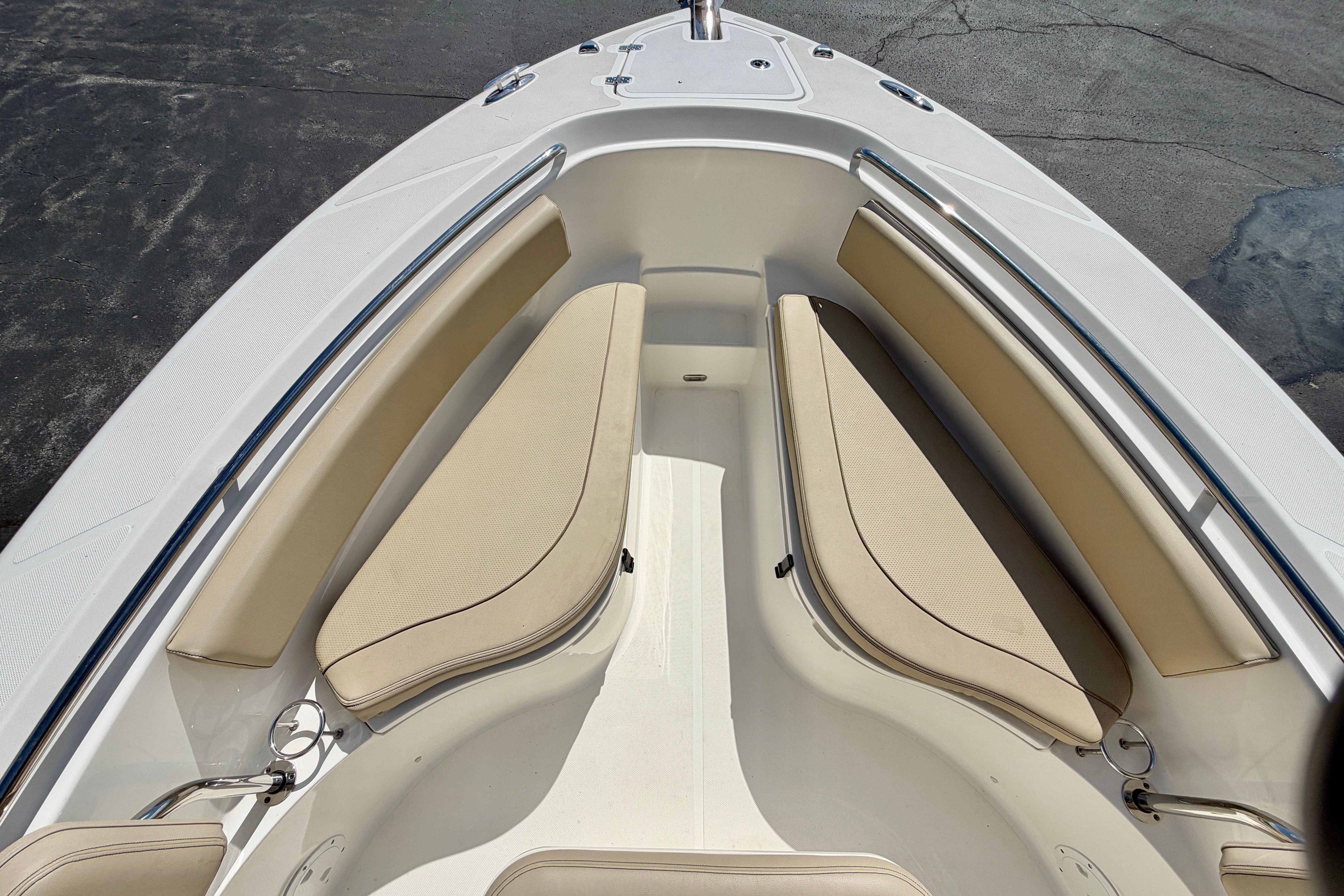 2020 Pursuit C 238 Center Console boat with beige seating and stainless steel railings.