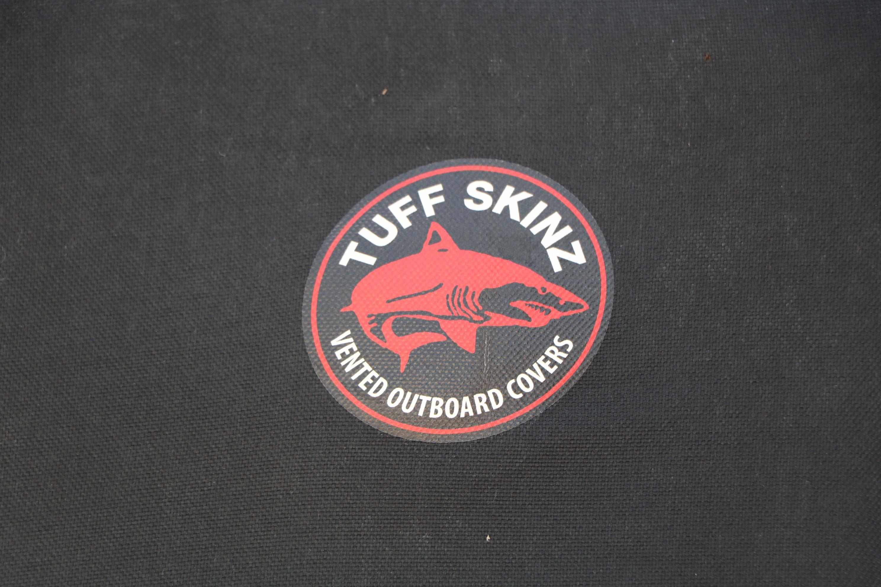 Tuff Skinz vented outboard covers logo on black fabric, 2023 Alumacraft Competitor FSX 185.