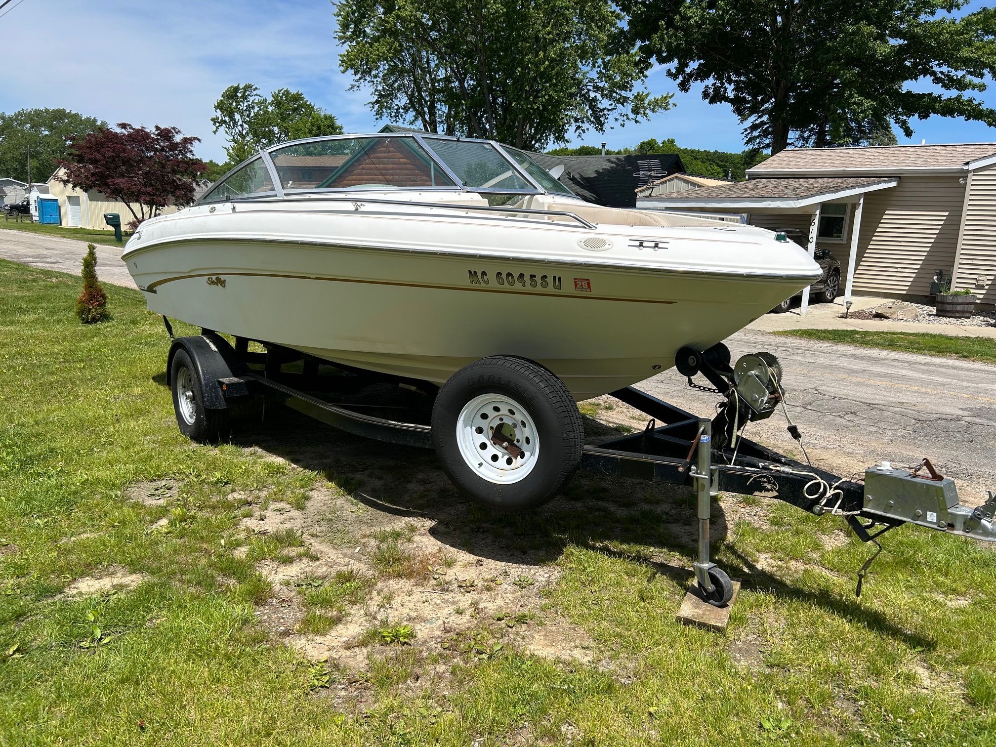 1998 Sea Ray 190 Bow Rider parked on trailer outdoors.