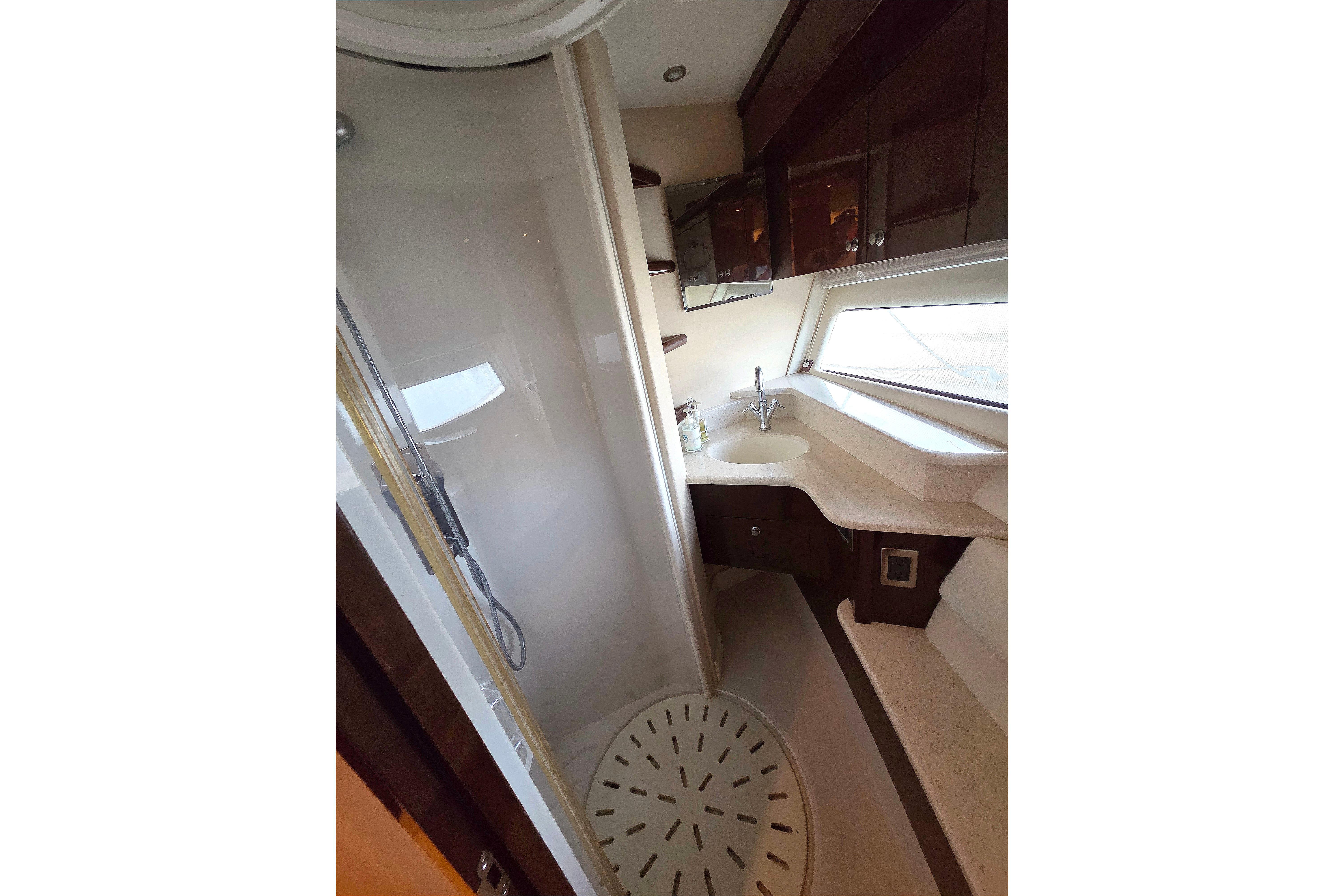 Luxurious bathroom in 2007 Marquis 55 LS yacht with modern fixtures and spacious shower.