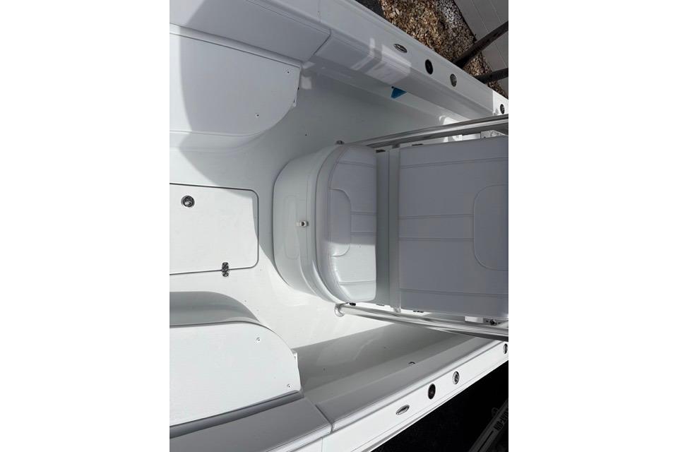 2025 Contender 26 Bay boat interior with white seating and storage compartments.