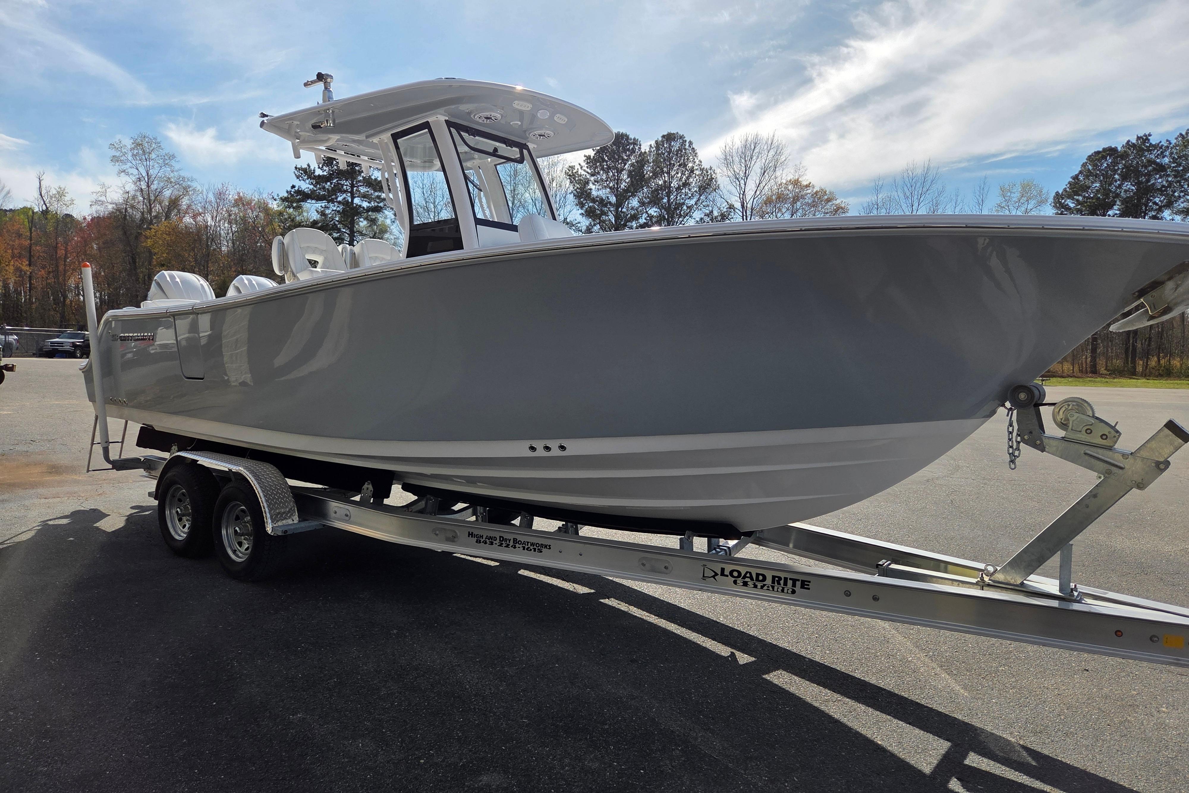 2026 Sportsman Heritage 261 Center Console boat on trailer, parked outdoors.