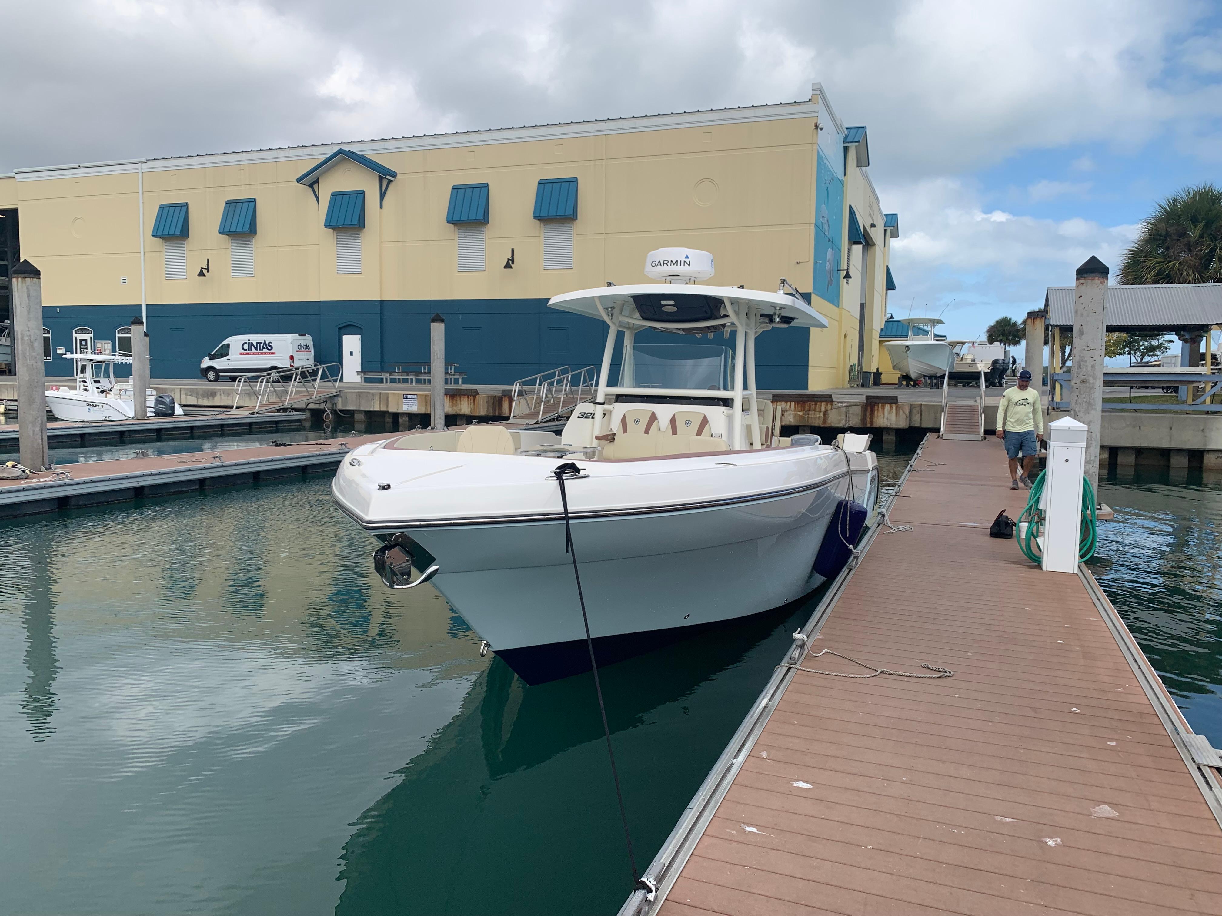 2019 Century 3200 Center Console boat docked at marina.