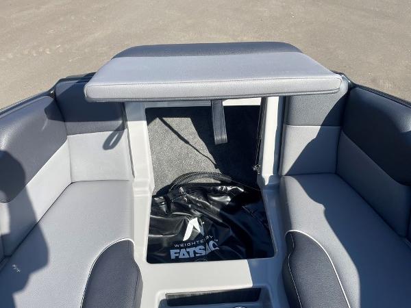2025 Moomba Mondo boat interior with gray seating and storage compartment.