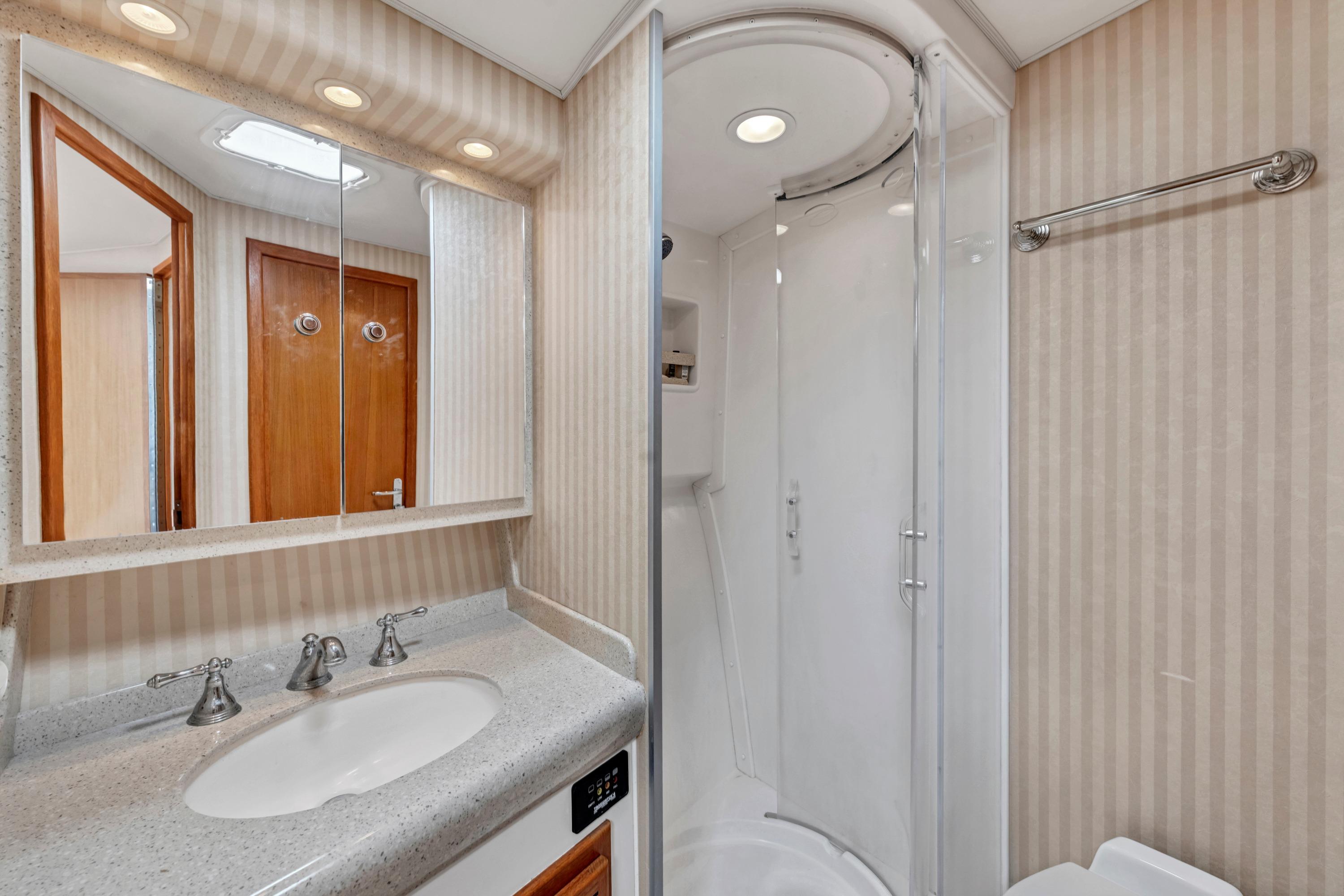 Luxurious bathroom in 2010 Cabo 45 Express yacht with modern fixtures and shower.