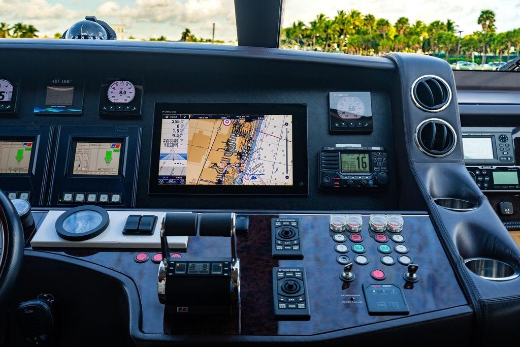 Control panel of a 2010 Princess 95 Motor Yacht with navigation screens and instruments.