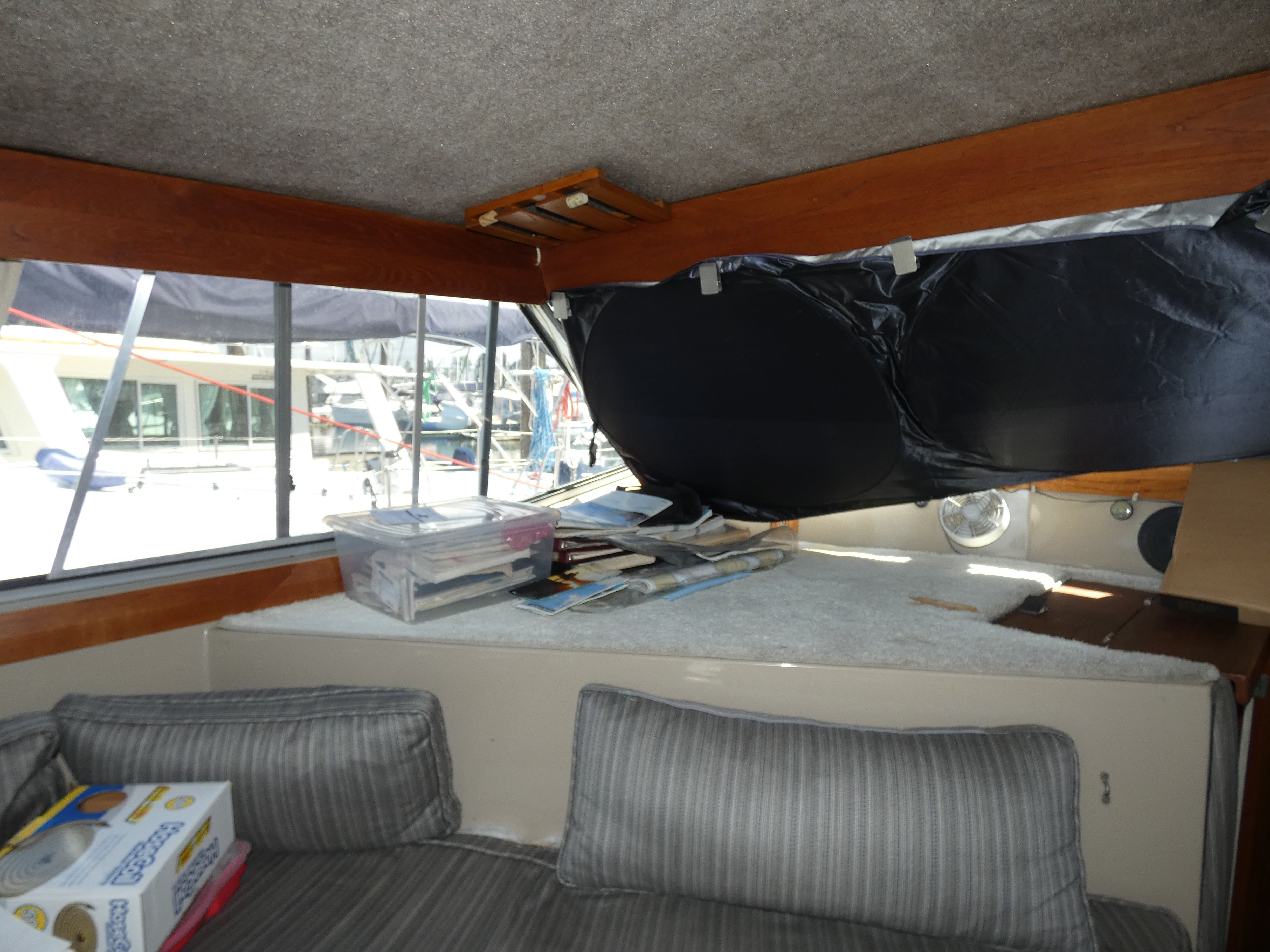 Interior of a 1984 Bayliner 3870 Motoryacht with cushions and windows.