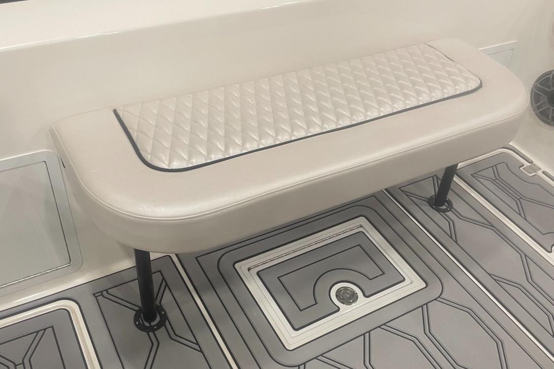 2025 Hustler 25 C3 Speedfish boat interior with cushioned bench seat and patterned flooring.