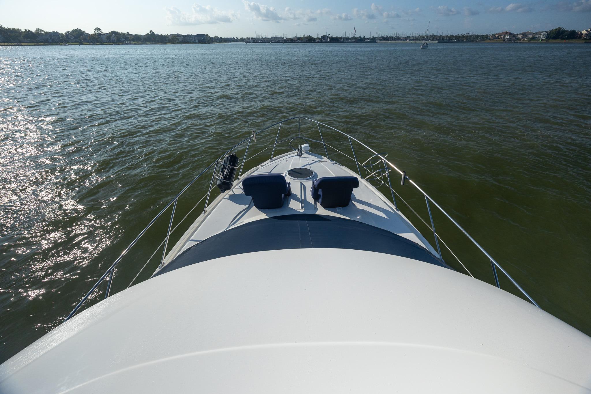 2010 Meridian 391 Sedan yacht cruising on calm waters under a clear sky.