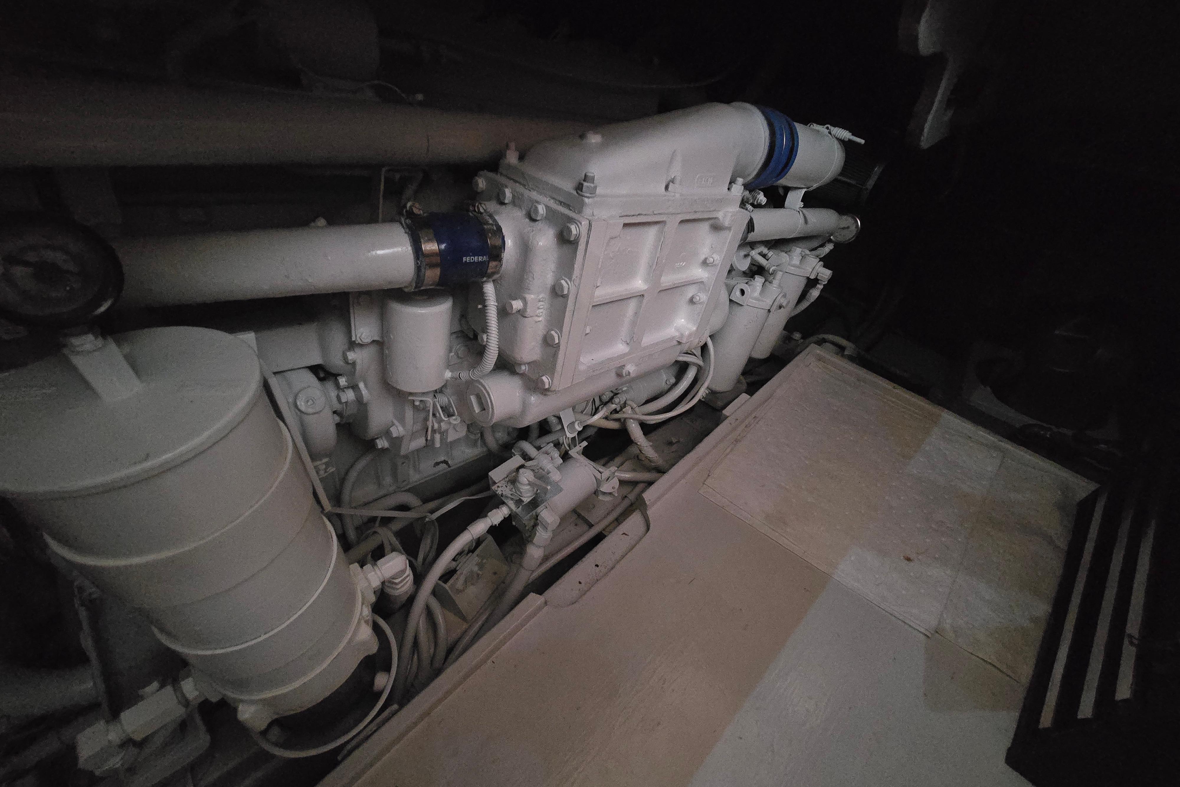 Engine room of a 1988 Post 46 Convertible boat, showcasing mechanical components.