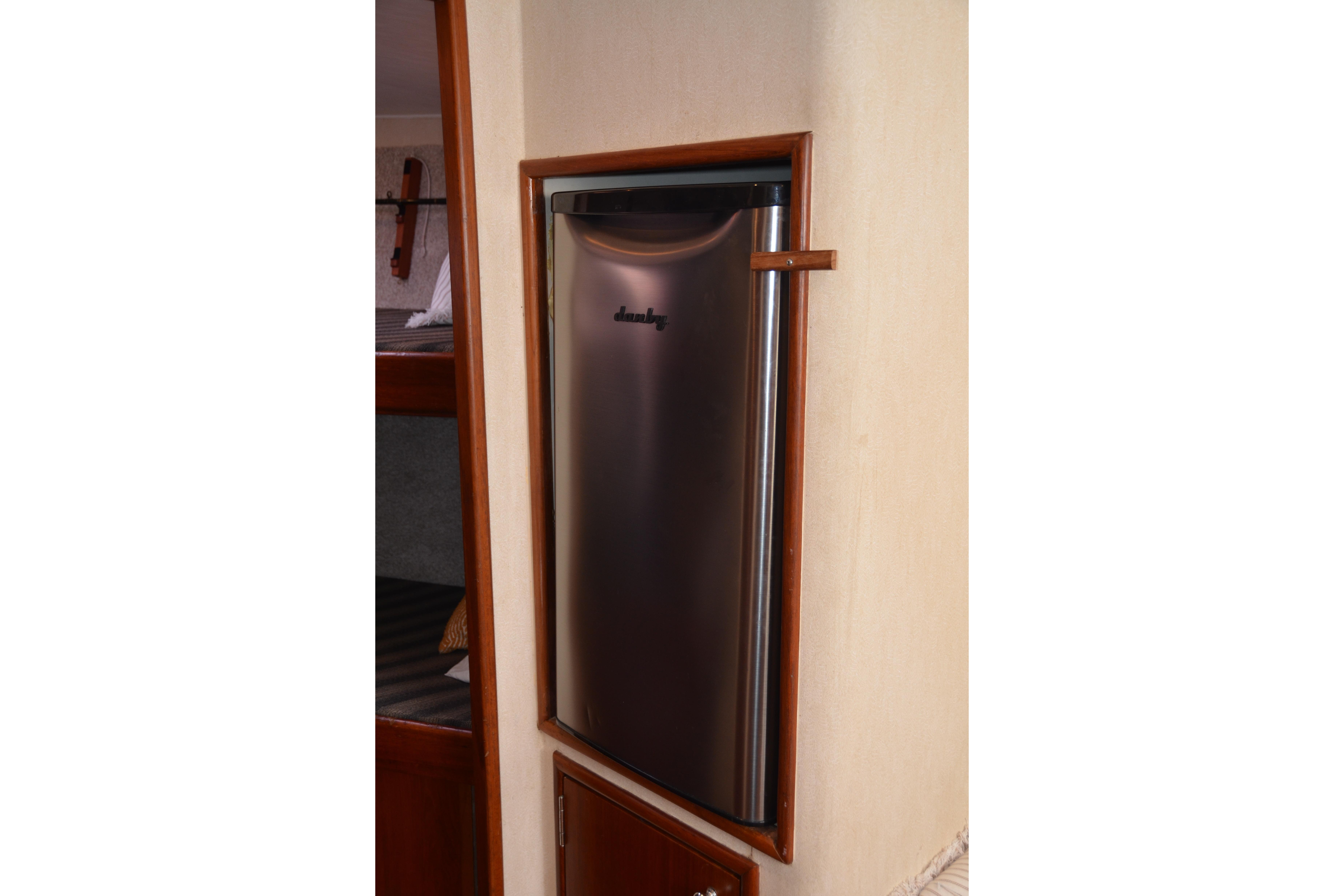 2006 Custom Carolina Heritage Express interior with compact stainless steel refrigerator.