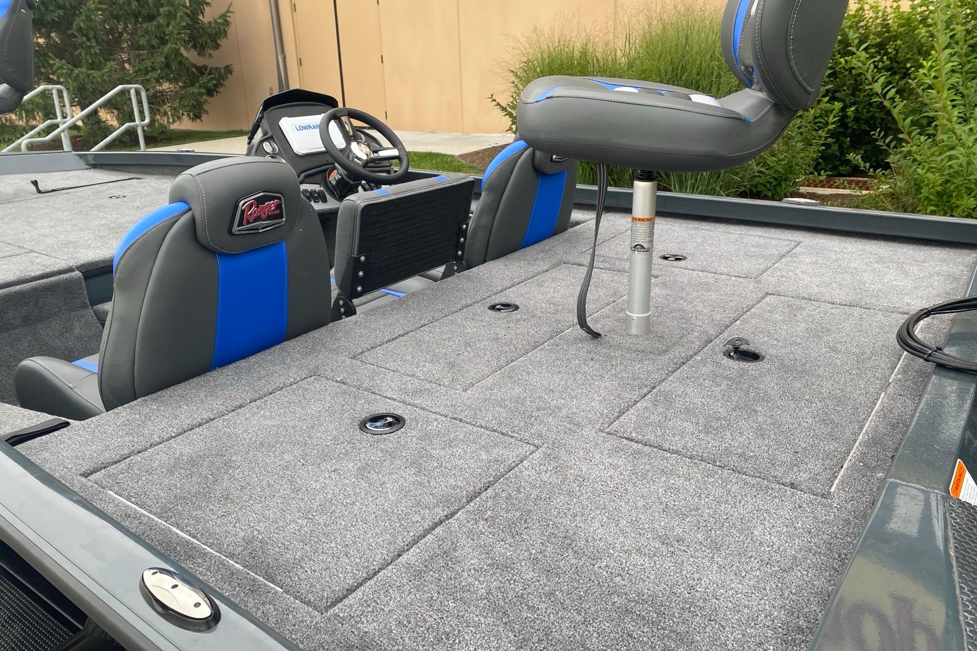 2026 Ranger RT188P boat interior with gray carpet and blue-accented seats.
