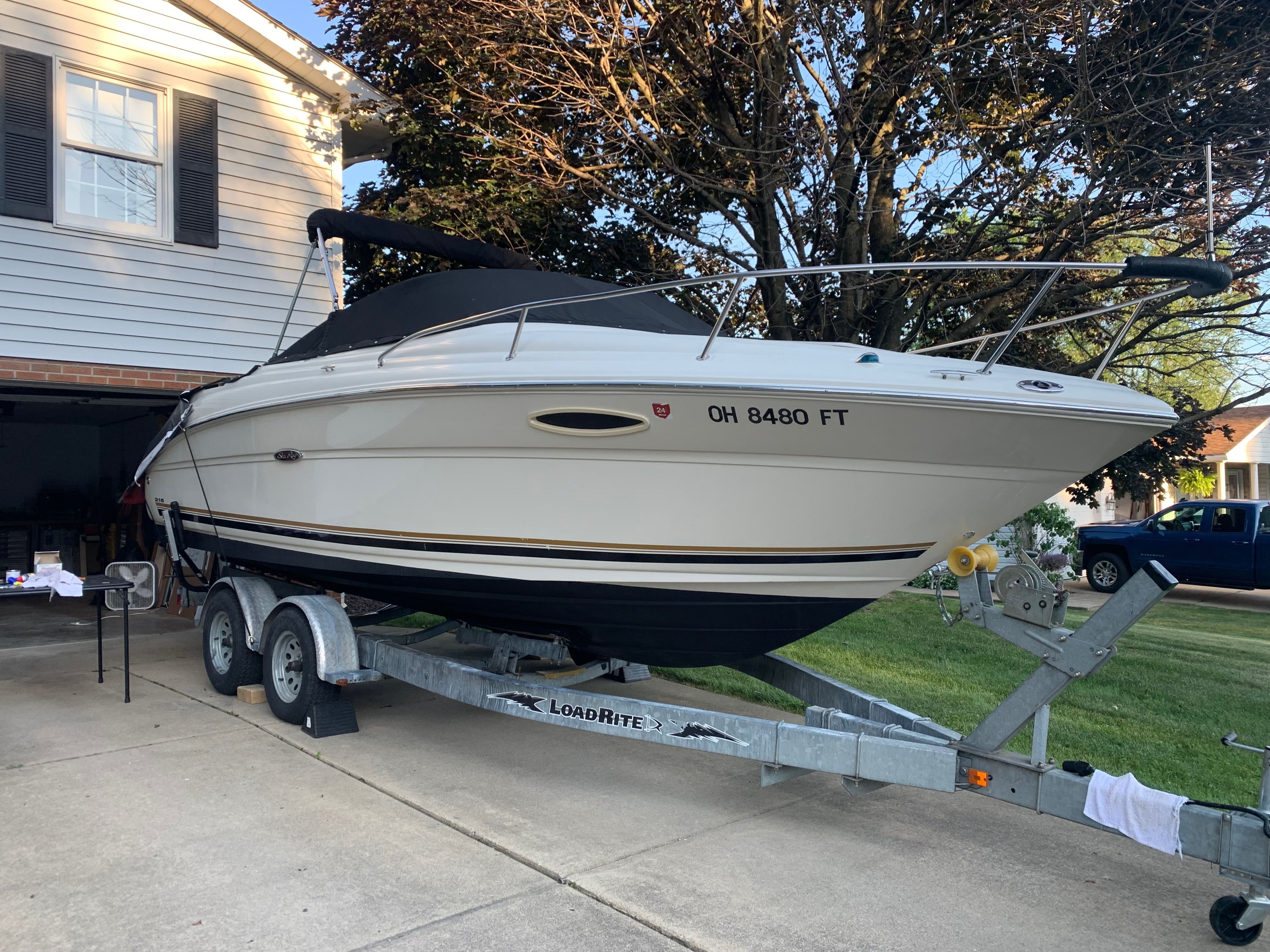 2006 Sea Ray 215 Weekender on trailer in driveway.