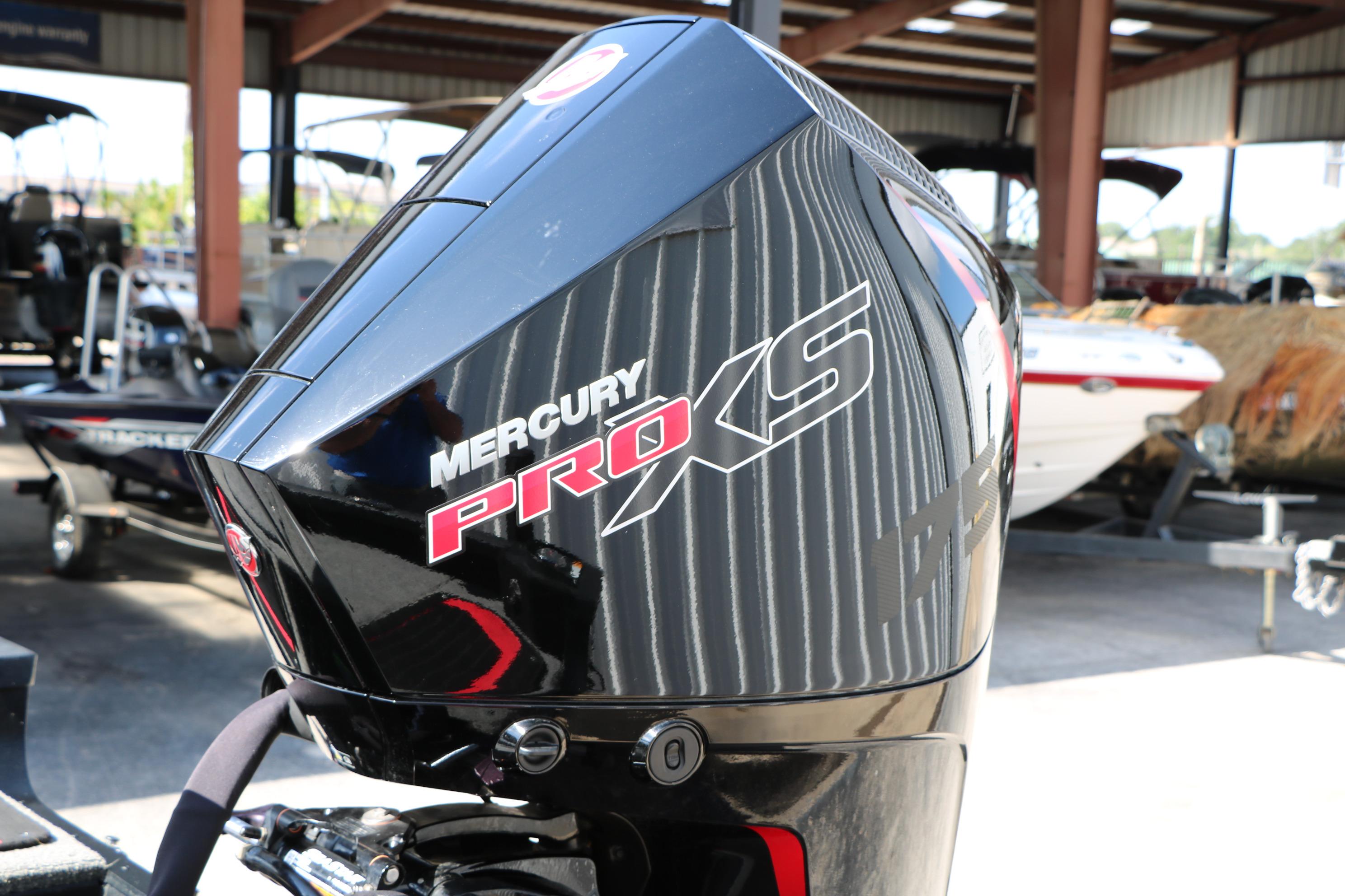 2023 Alumacraft Competitor FSX 185 with Mercury Pro XS engine in a boat showroom.