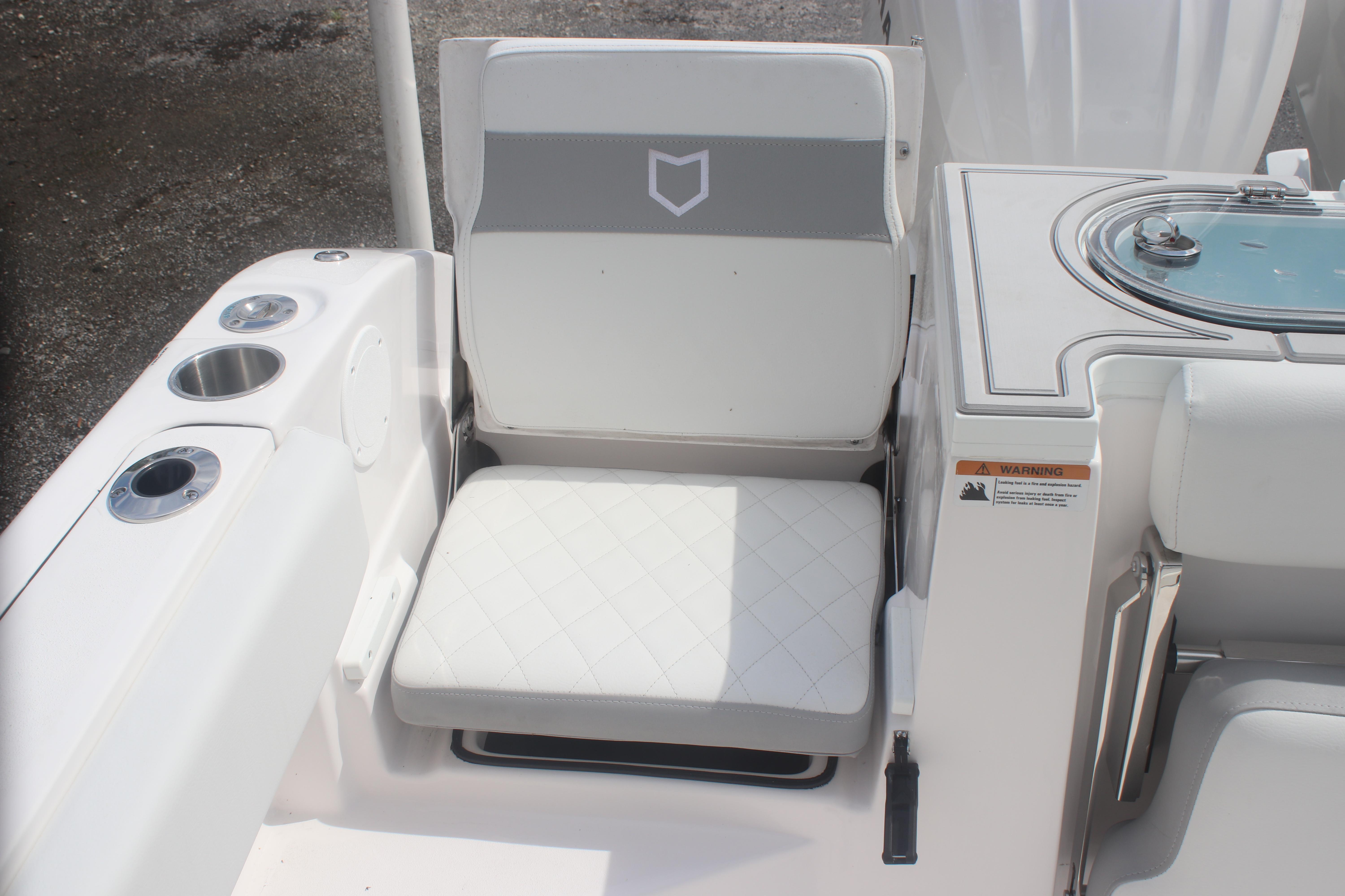 2026 Sea Fox 288 Commander boat seat with cup holders and storage compartment.