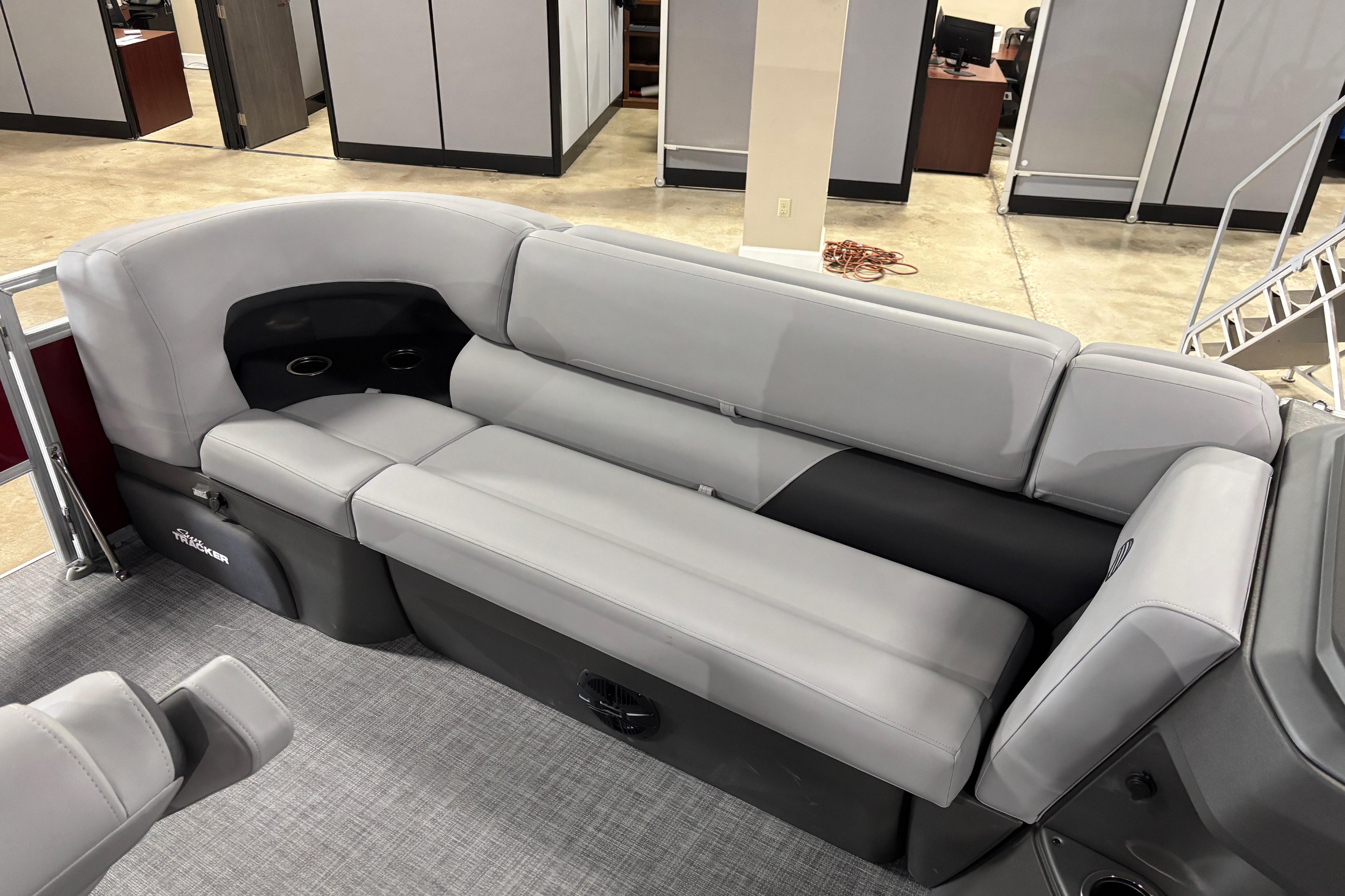 2026 Sun Tracker SportFish 20 DLX boat interior with gray seating and cup holders.