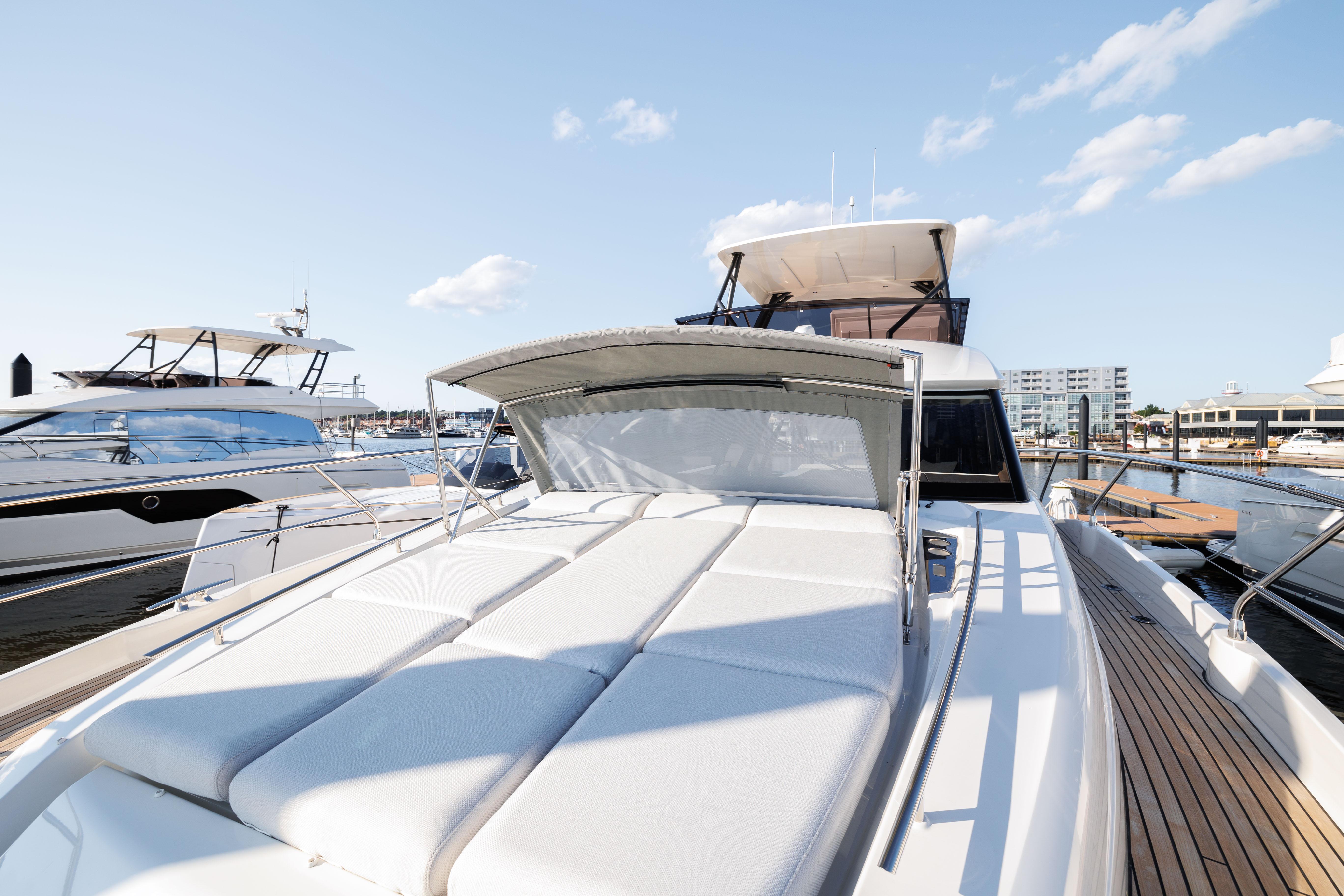 2024 Prestige 520 yacht docked at marina under clear sky.