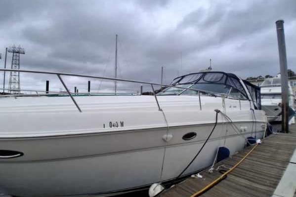 2000 Sea Ray 460 Sundancer yacht docked under cloudy skies.